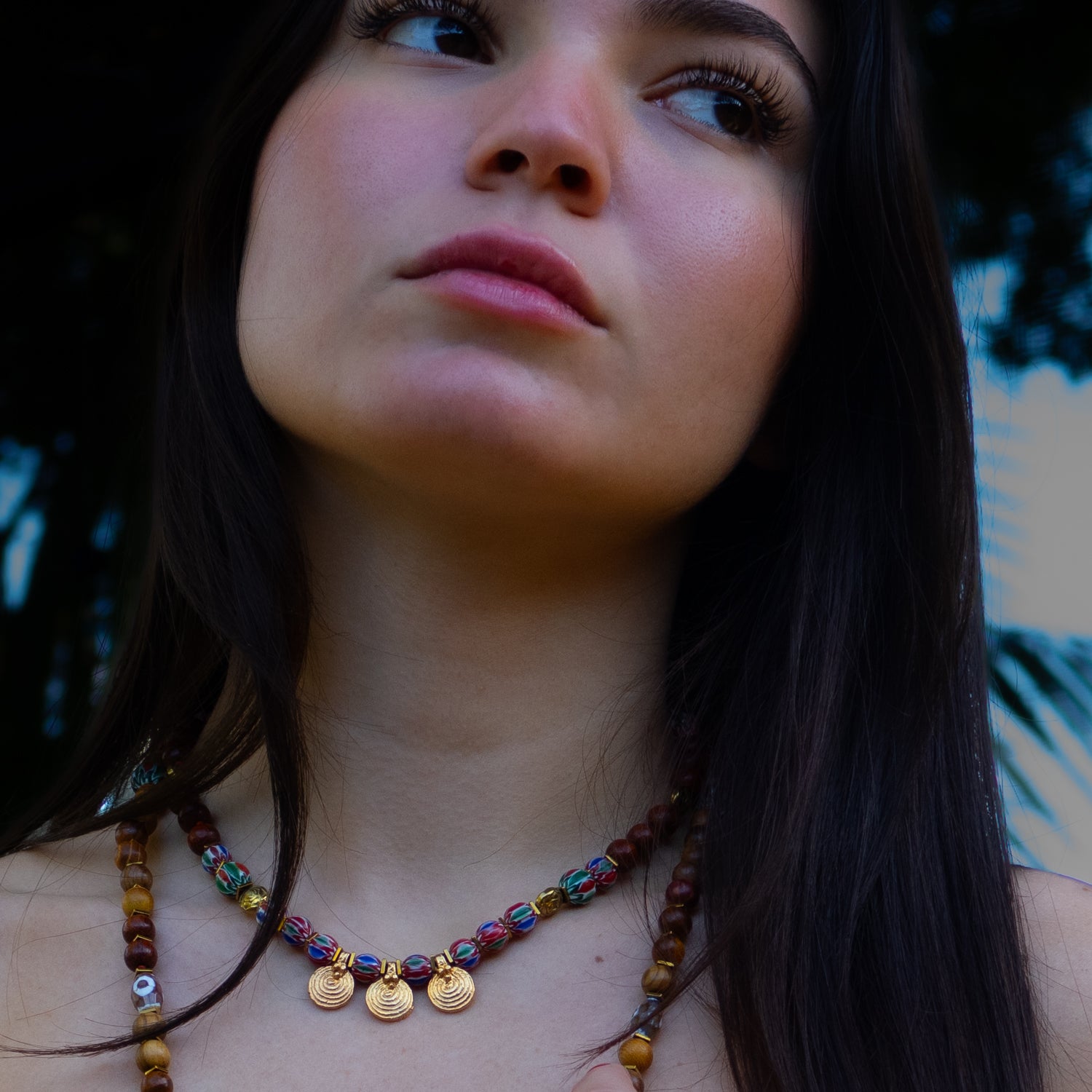 Bohemian-Inspired Gold Spiral Charm Necklace with Wooden and African Beads for a Vibrant Look