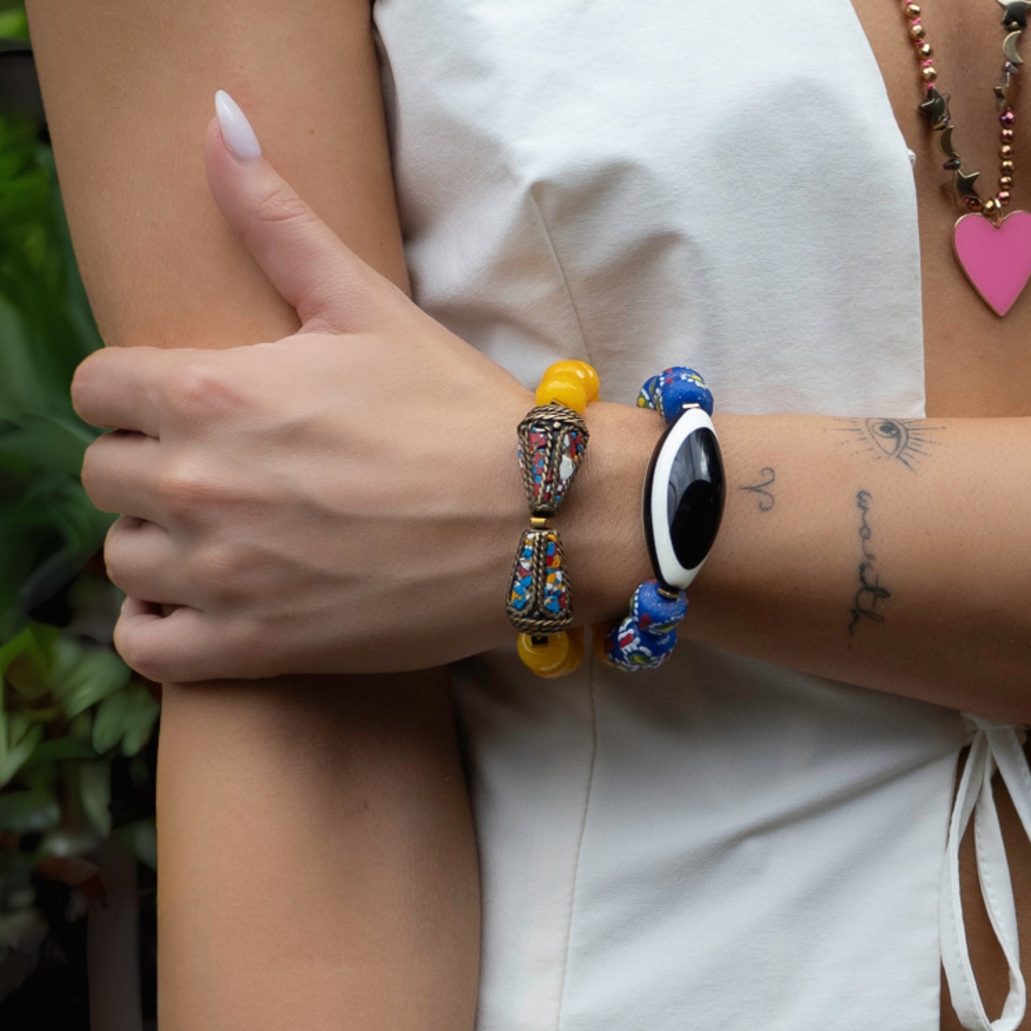 Handcrafted chunky bracelet with vibrant blue Evil Eye beads, bright yellow jade stones, and a Nepal protection bead.