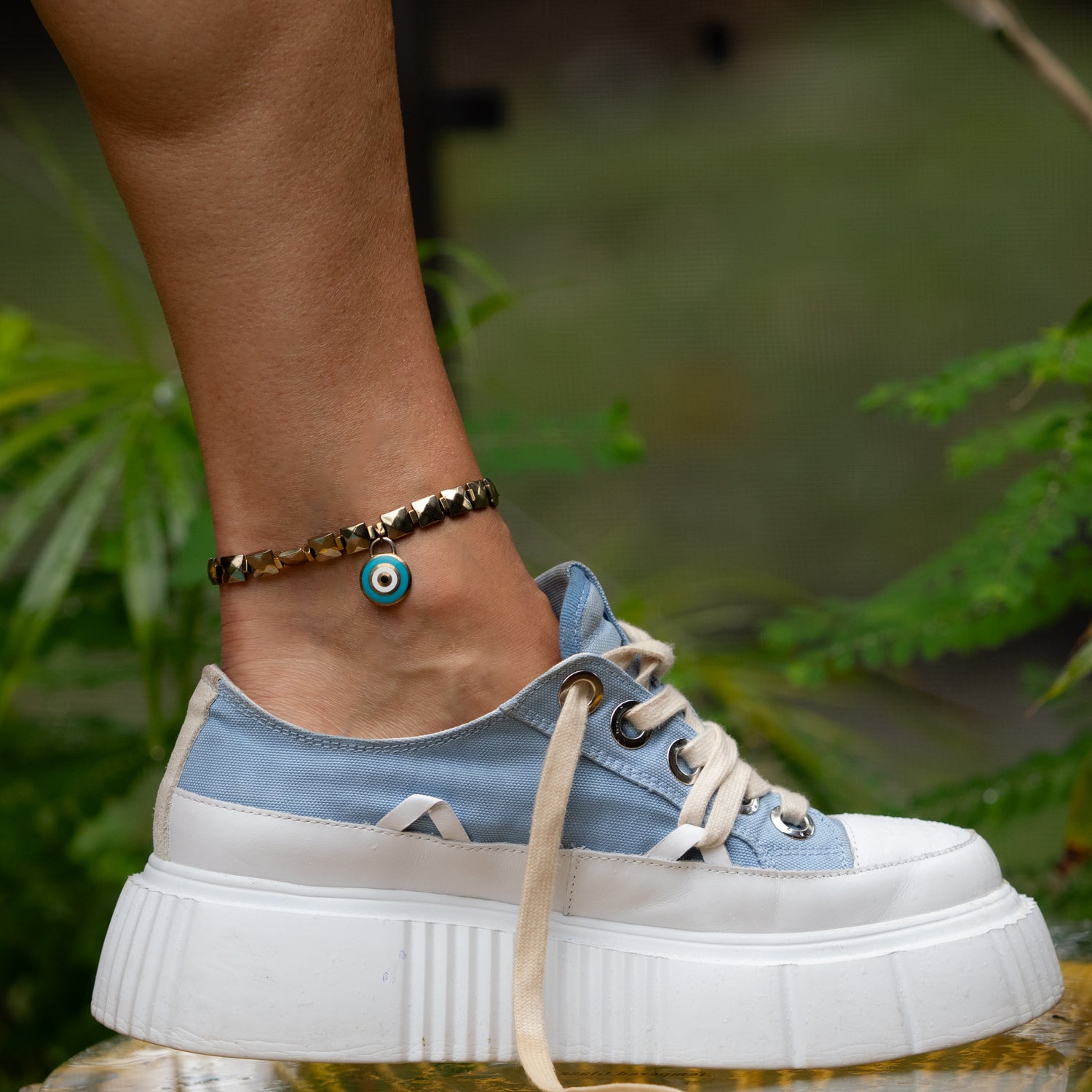 Handmade gold-tone hematite ankle bracelet featuring evil eye protection charm