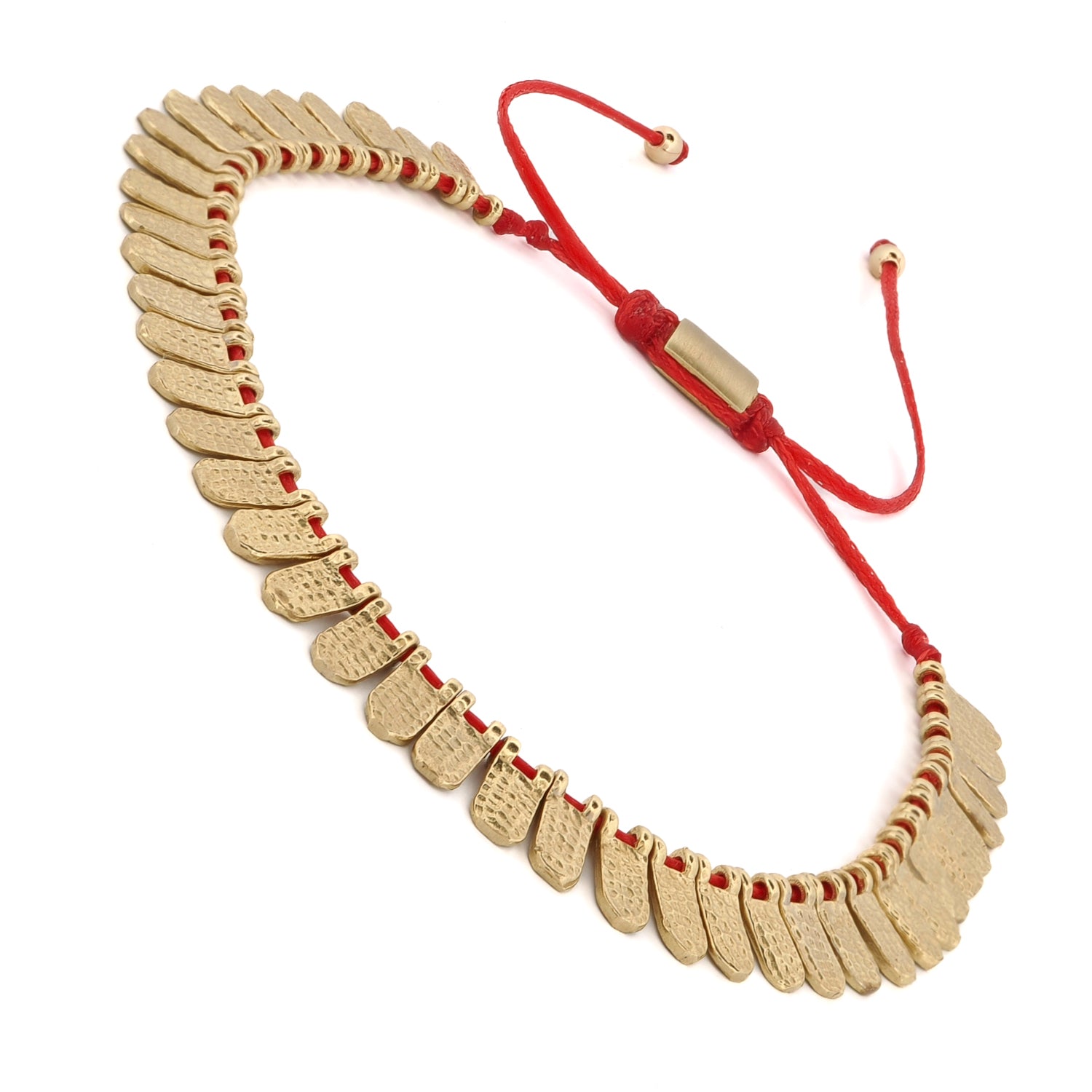 Close-up of a Fish Scale Bracelet with gold-plated charms and an adjustable red cord for a striking look.