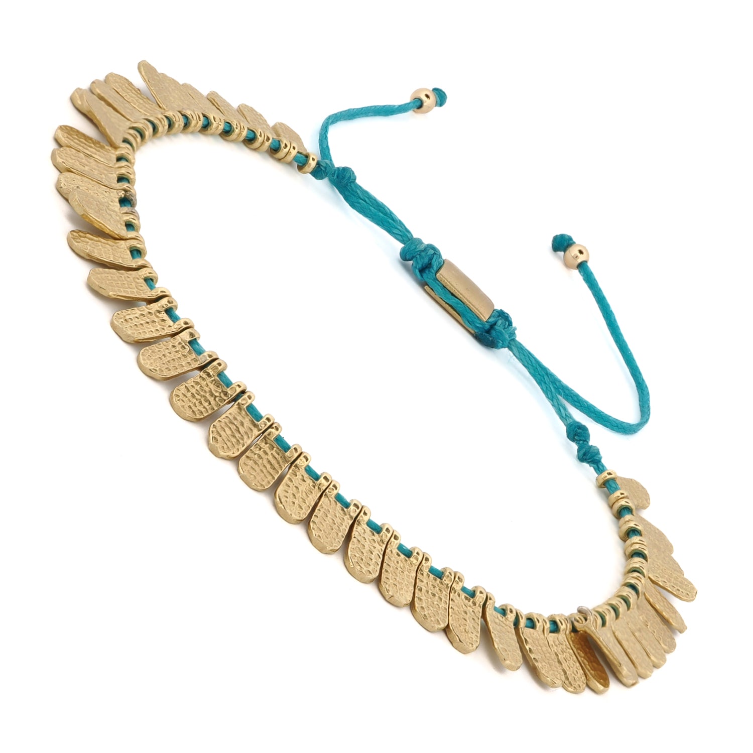 Close-up of a Fish Scale Bracelet with gold-plated charms and an adjustable turquoise cord design.