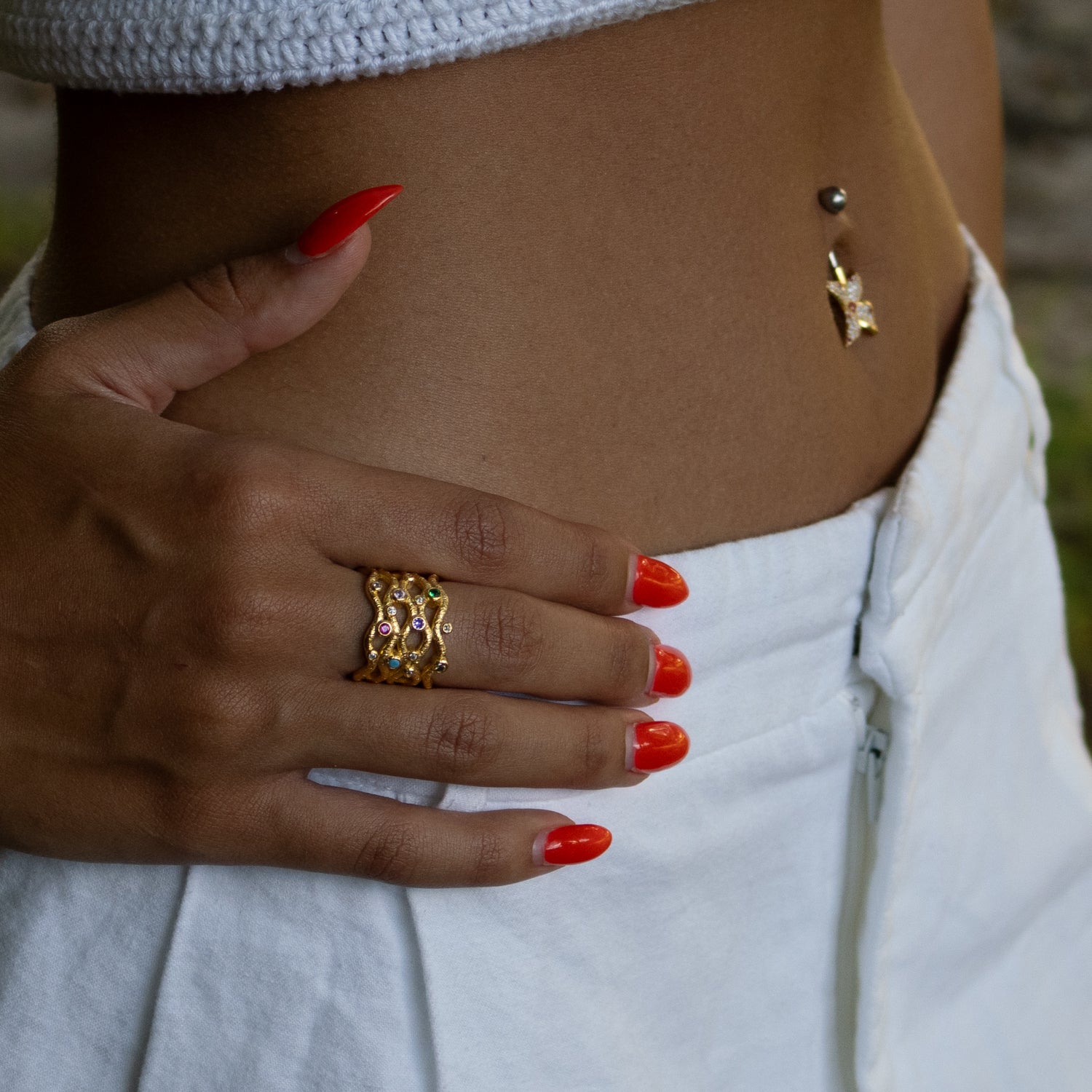 Sterling silver belly button ring with gold-plated flower, sparkling cubic zirconia stones, and pink ruby accent gems