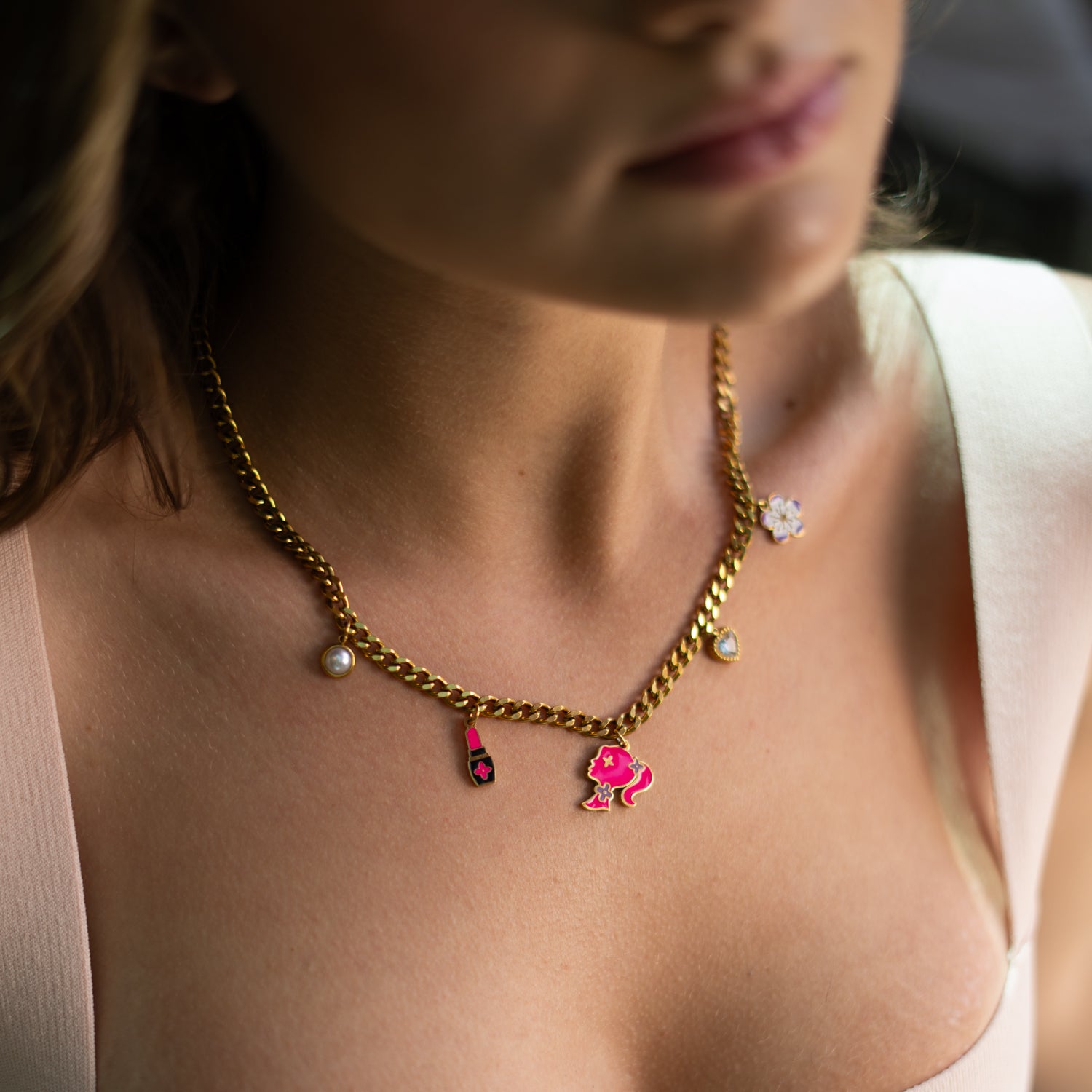 Lightweight gold charm necklace with enamel accents and stylish design