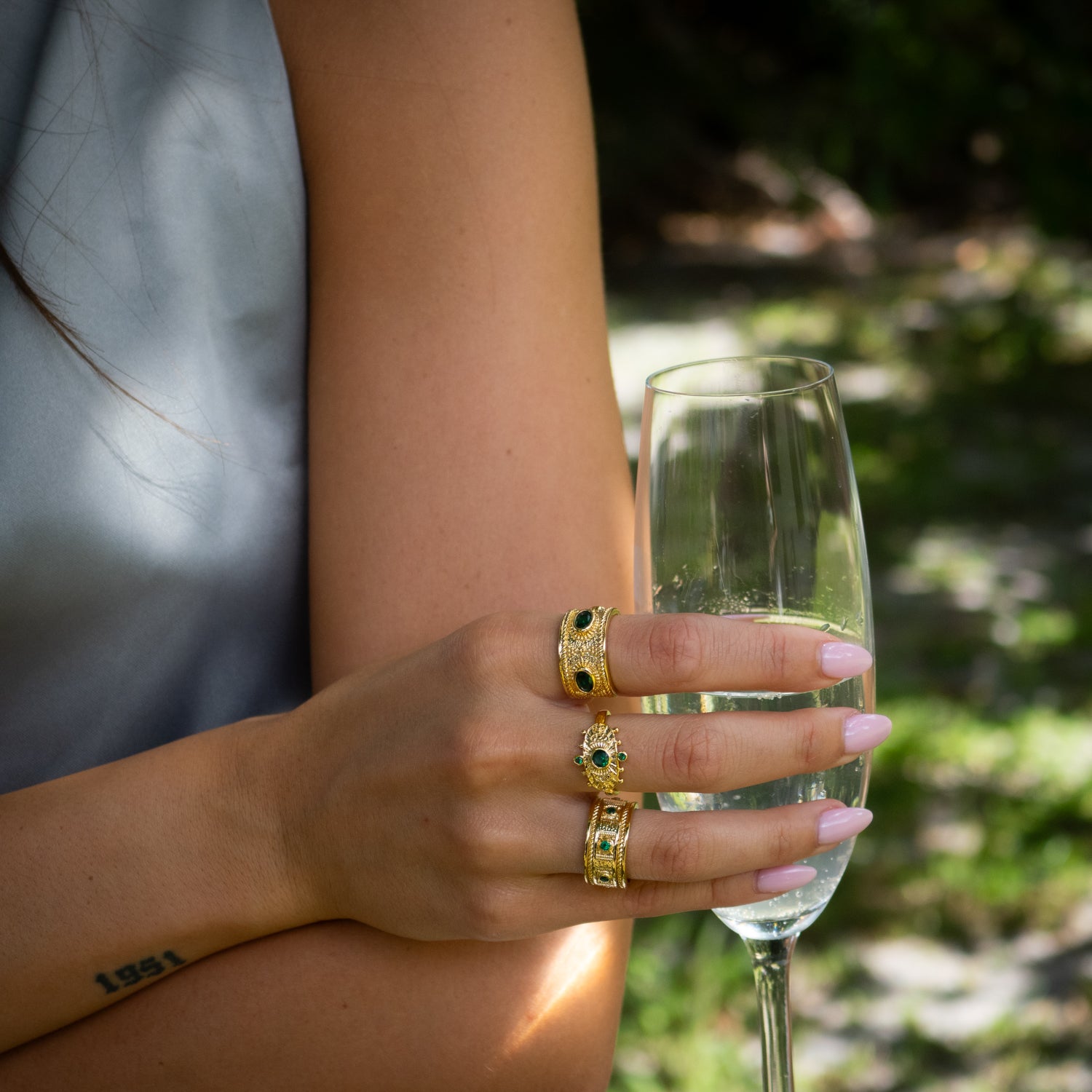 Statement ring blending rich 24K gold finish, sacred emerald energy, and ancient Egyptian patterns.