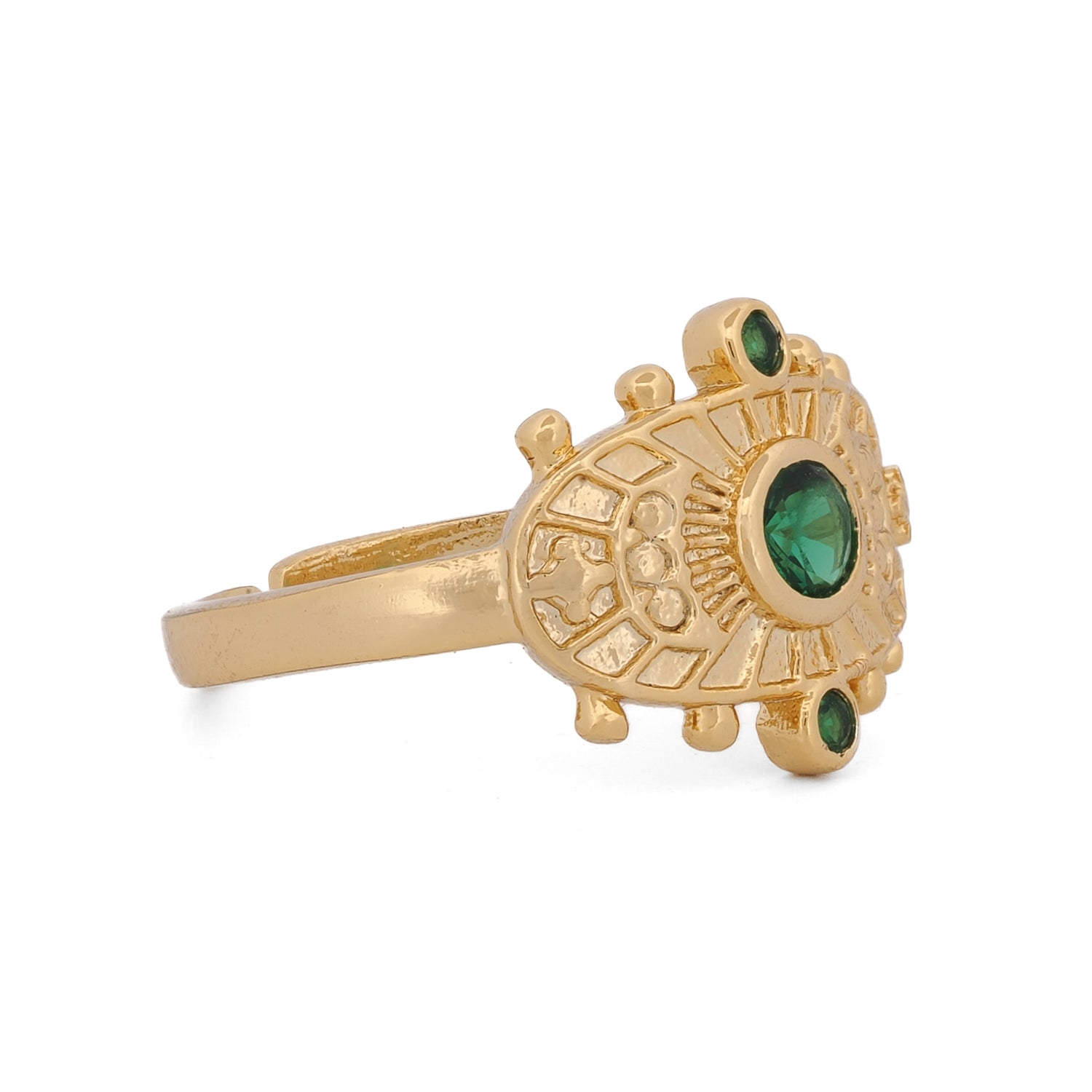 Close-up of radiant gold ring with green emerald stone symbolizing healing and spiritual growth.