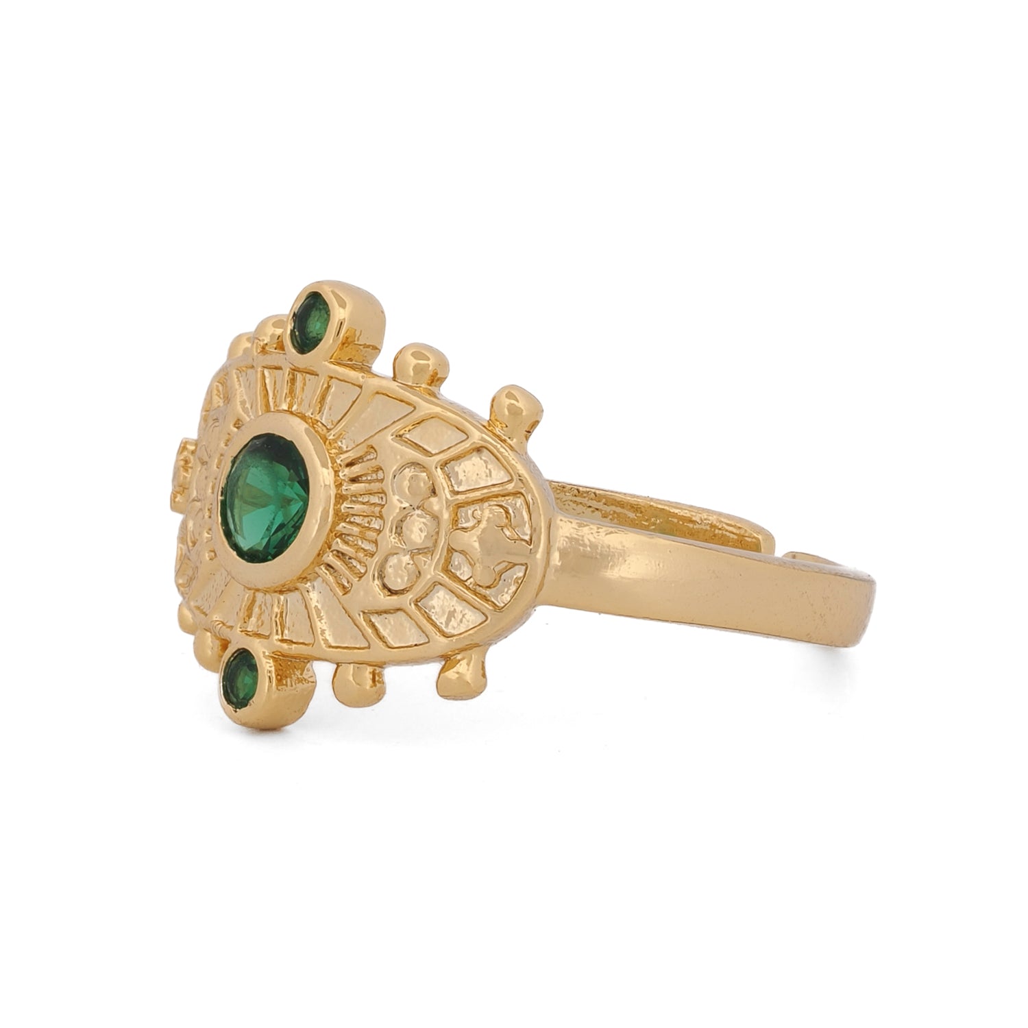 Unique gold ring crafted on bronze with intricate symbols and deep green emerald stone.