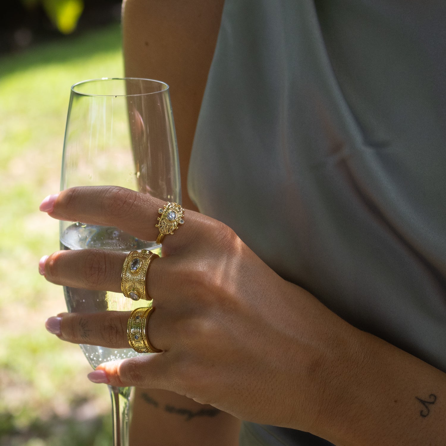 Unique gold ring crafted on bronze with intricate geometric carvings and diamond accents.