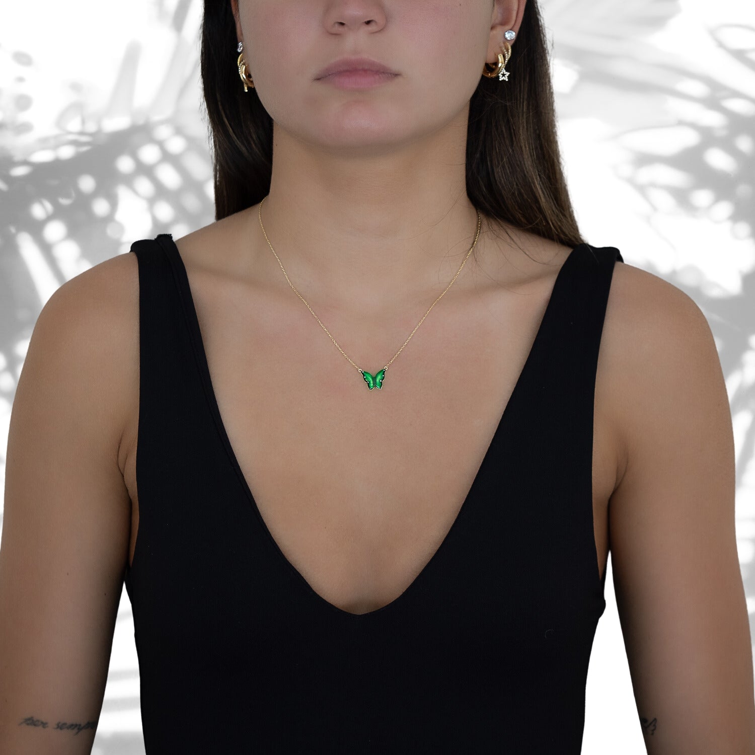 Stylish shot of a model wearing the Gold Abundance Green Enamel Butterfly Necklace, radiating confidence and showcasing its spiritual and aesthetic appeal.