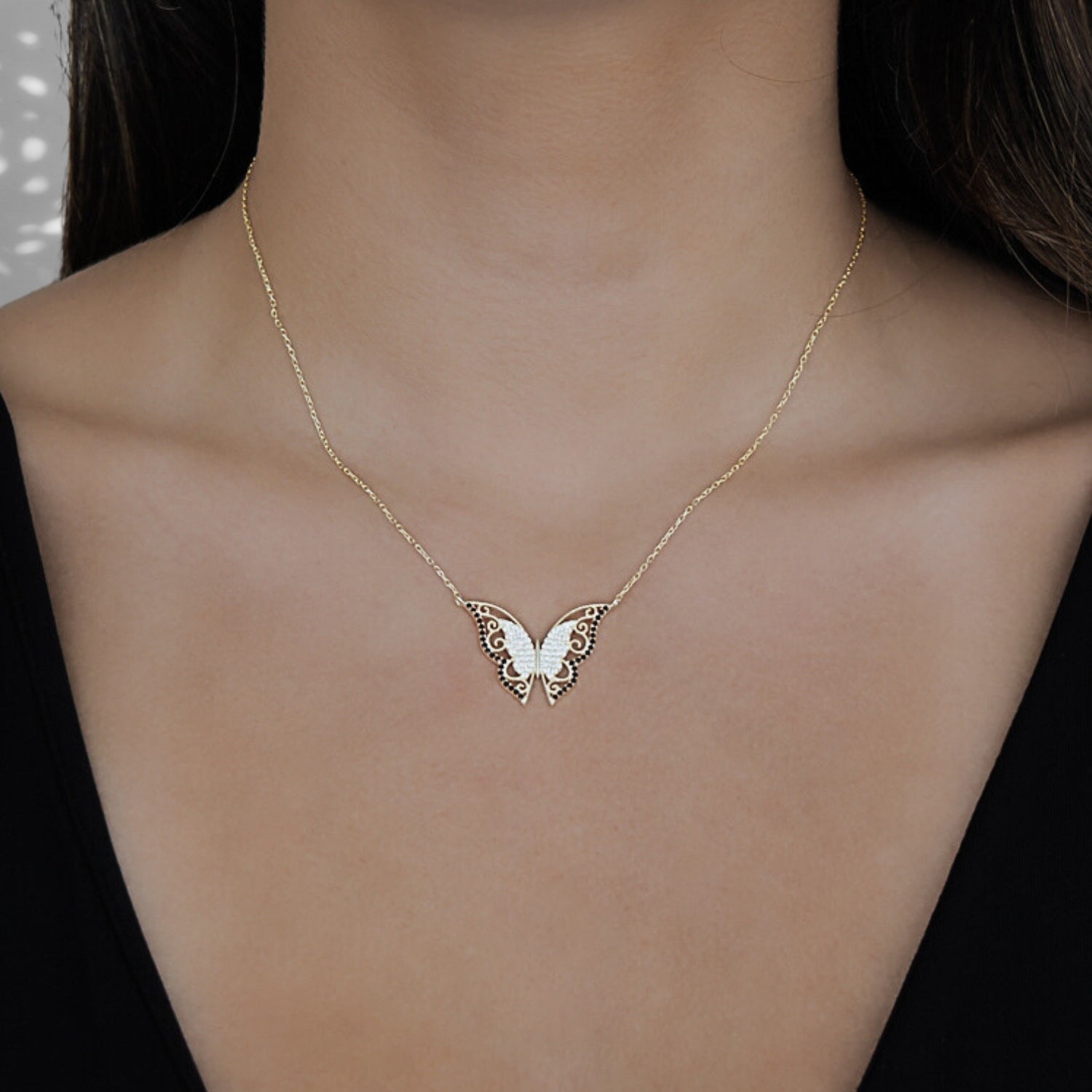Model wearing the Gold Sparkly Joyful Butterfly Necklace, radiating joy and embracing the transformative symbolism of the butterfly.