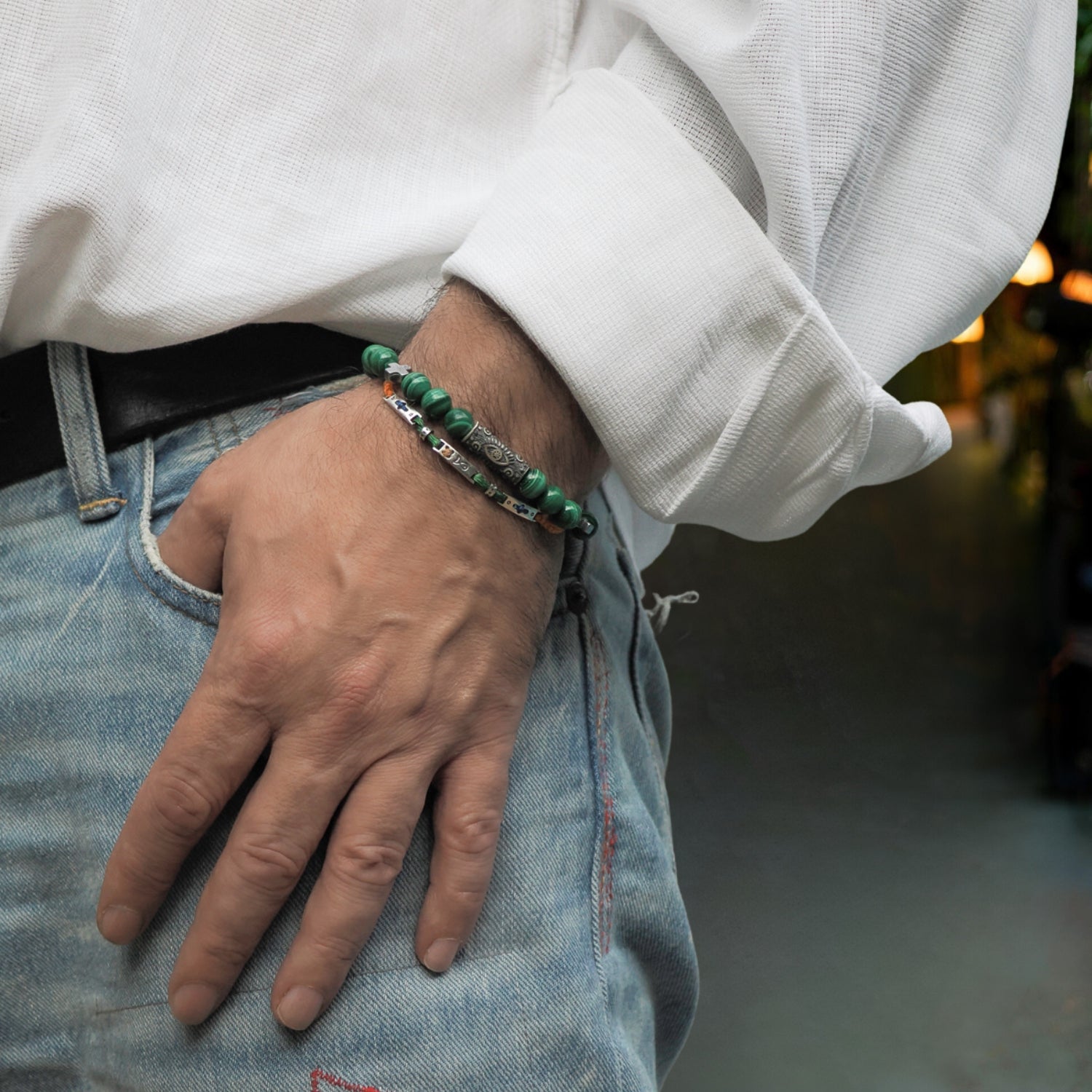 Handcrafted beaded bracelet with vibrant green malachite gemstones and a sterling silver Evil Eye bead.