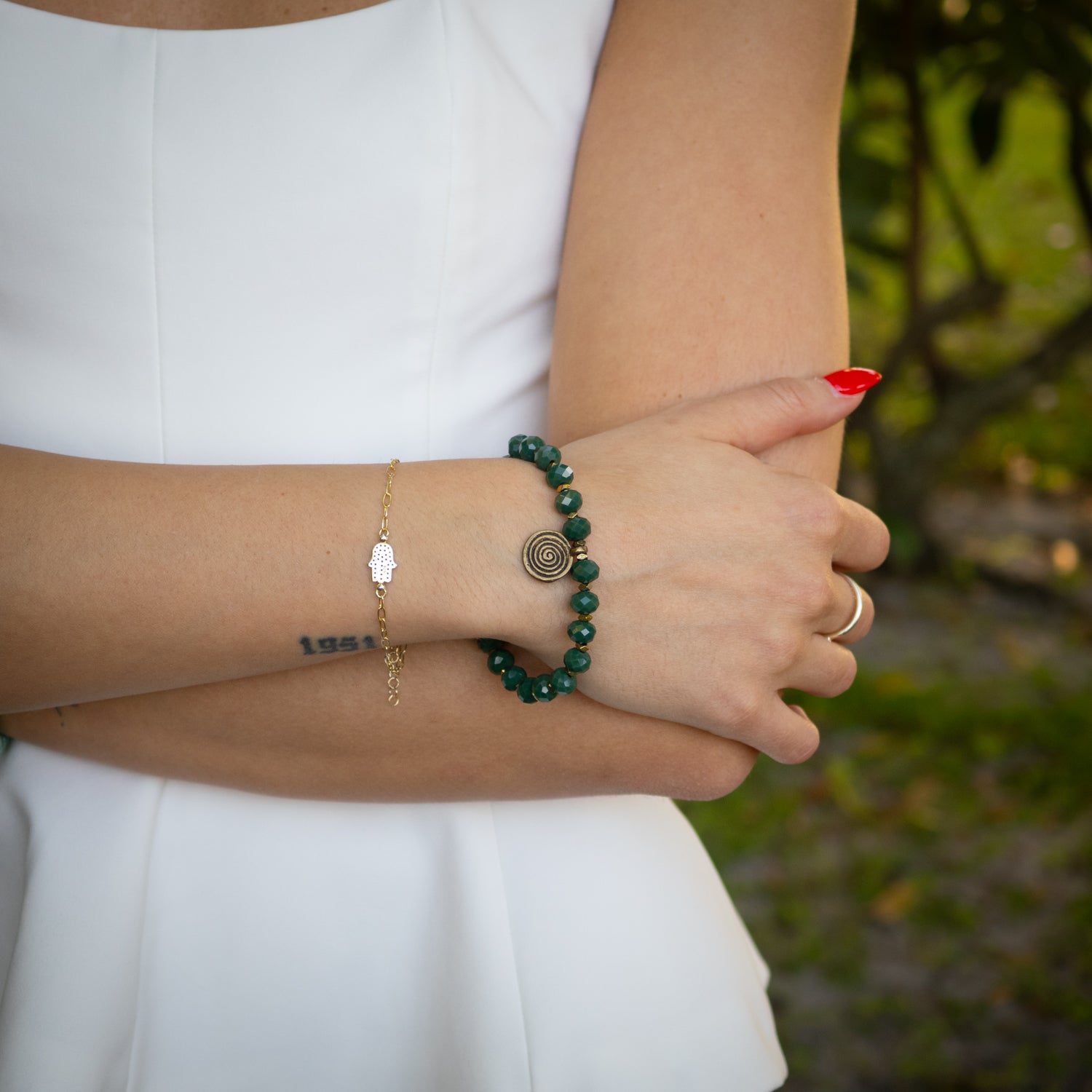 Handmade Green Spiral Beaded Bracelet with eye motif Nepal bead and brass charm.