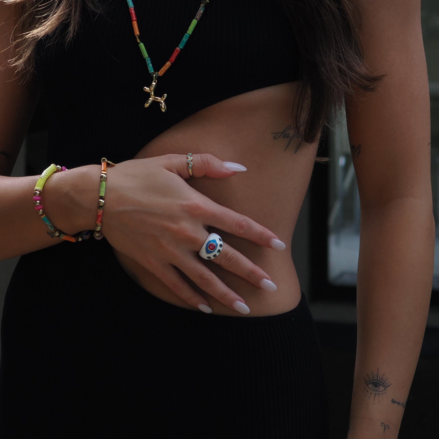 Stylish adjustable ring with a guardian Evil Eye motif, adorned with ruby and emerald on 18K gold-plated sterling silver.