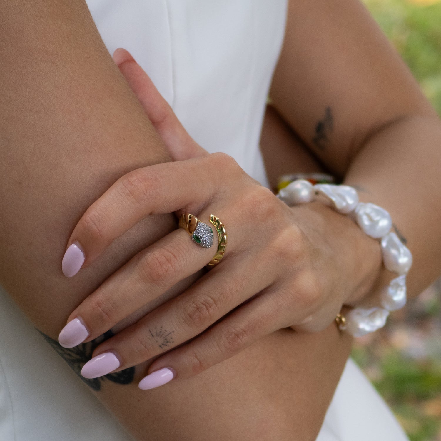 Fashion-forward gold snake ring with encrusted CZ stones and symbolic energy