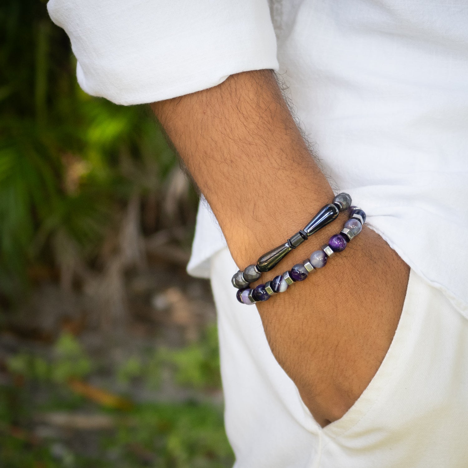 Faceted hematite men's bracelet with teardrop beads and sterling silver rhodium plated accents.