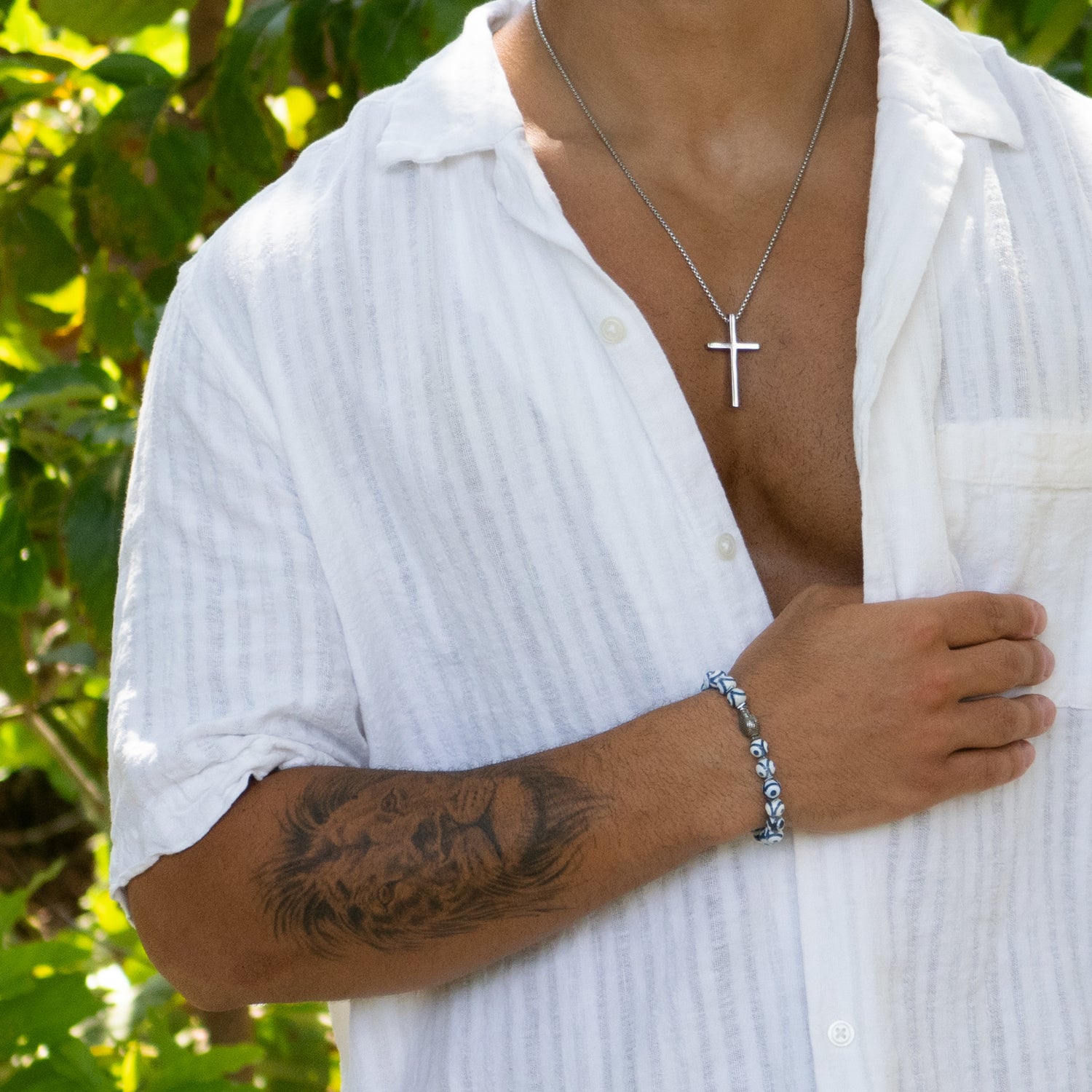 Minimalist silver cross necklace for men with “Immanuel” engraved on the side.
