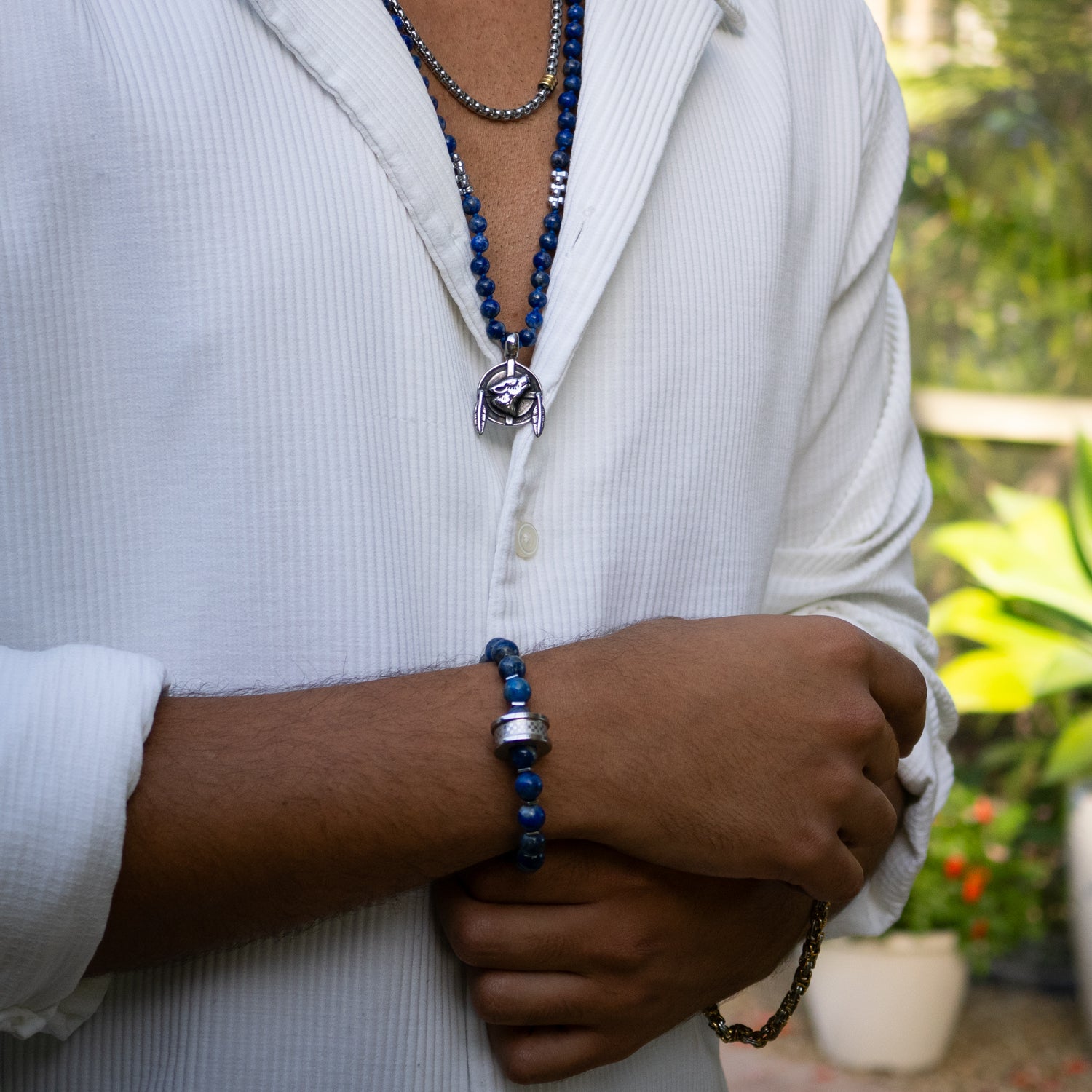 Handmade bracelet featuring 8mm blue lapis lazuli stones and unique steel Amor bead.