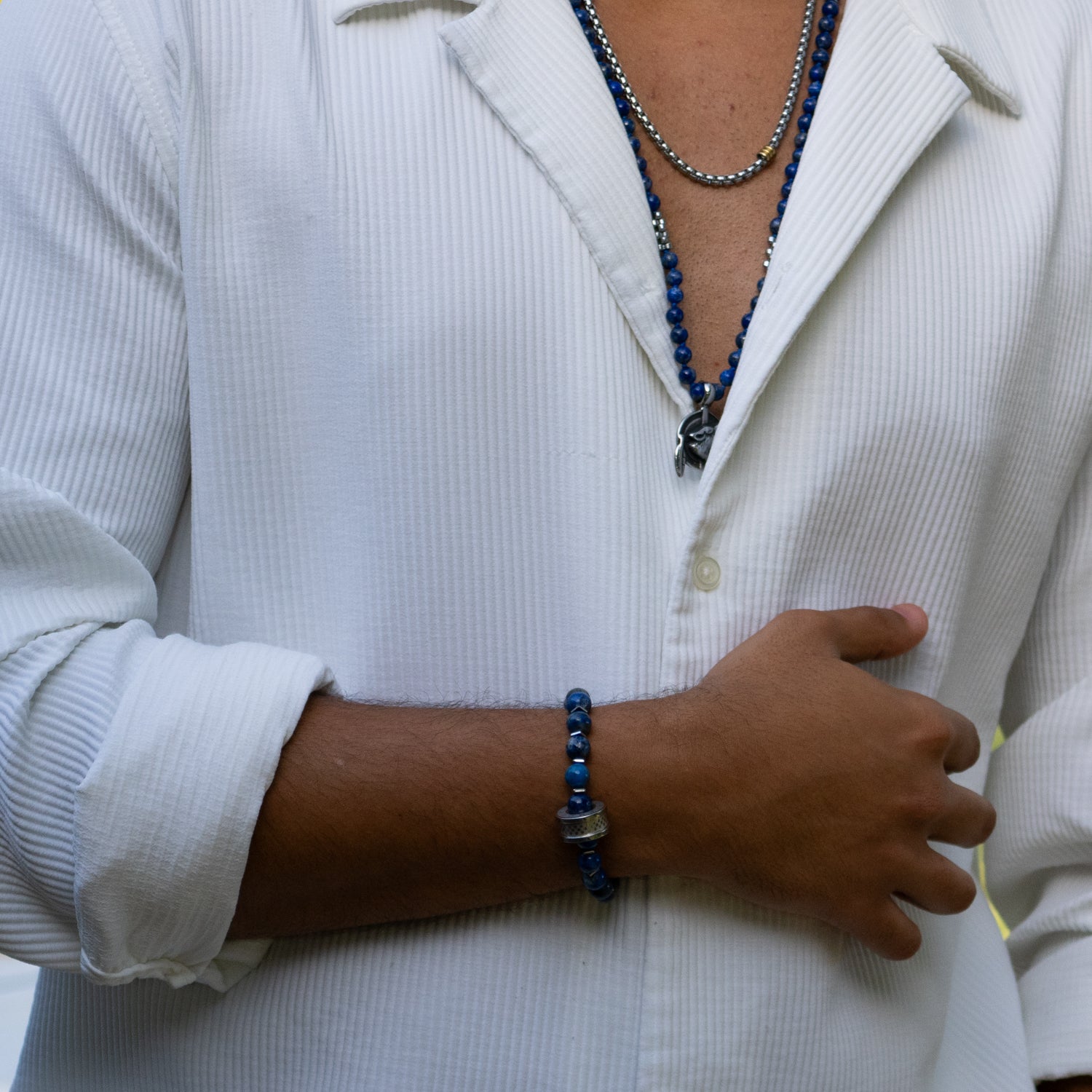 Close-up of lapis lazuli bracelet with silver accents and Amor bead symbolizing love and harmony.