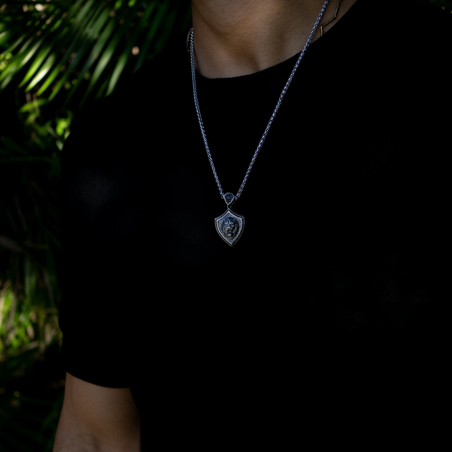 Men’s sterling silver Lionheart Shield necklace with a 3D lion head on a shield pendant, rhodium-plated finish, and polished chain.