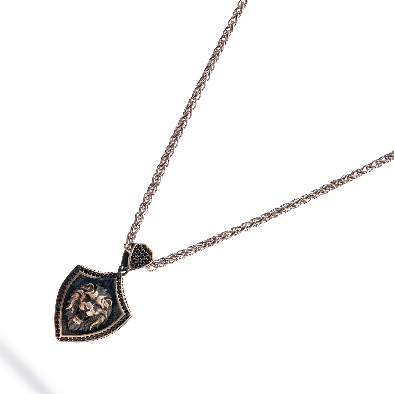 Sterling silver men’s necklace with shield pendant featuring a raised lion head design, rhodium finish, and polished silver chain.