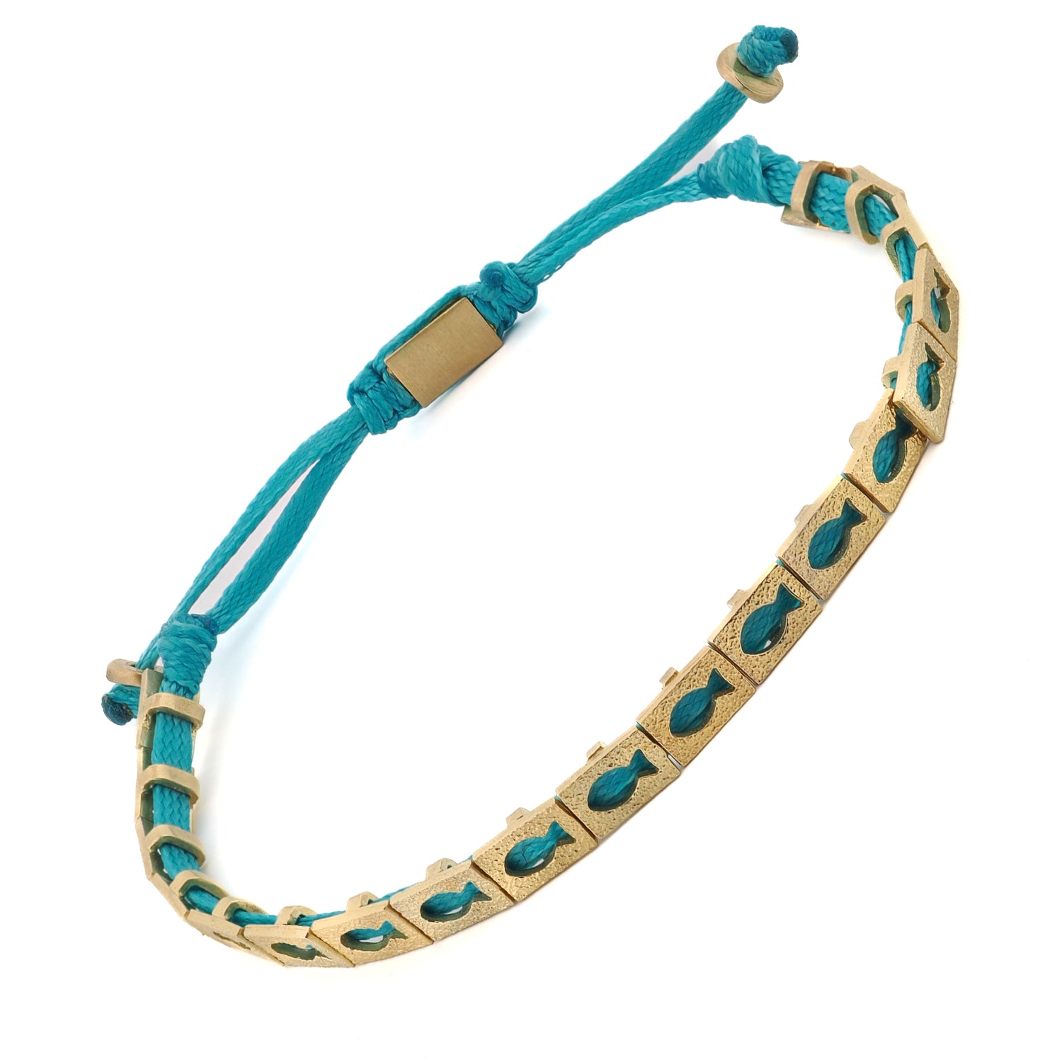 Handcrafted turquoise bracelet with wealth-attracting gold fish symbols, shown worn on wrist.