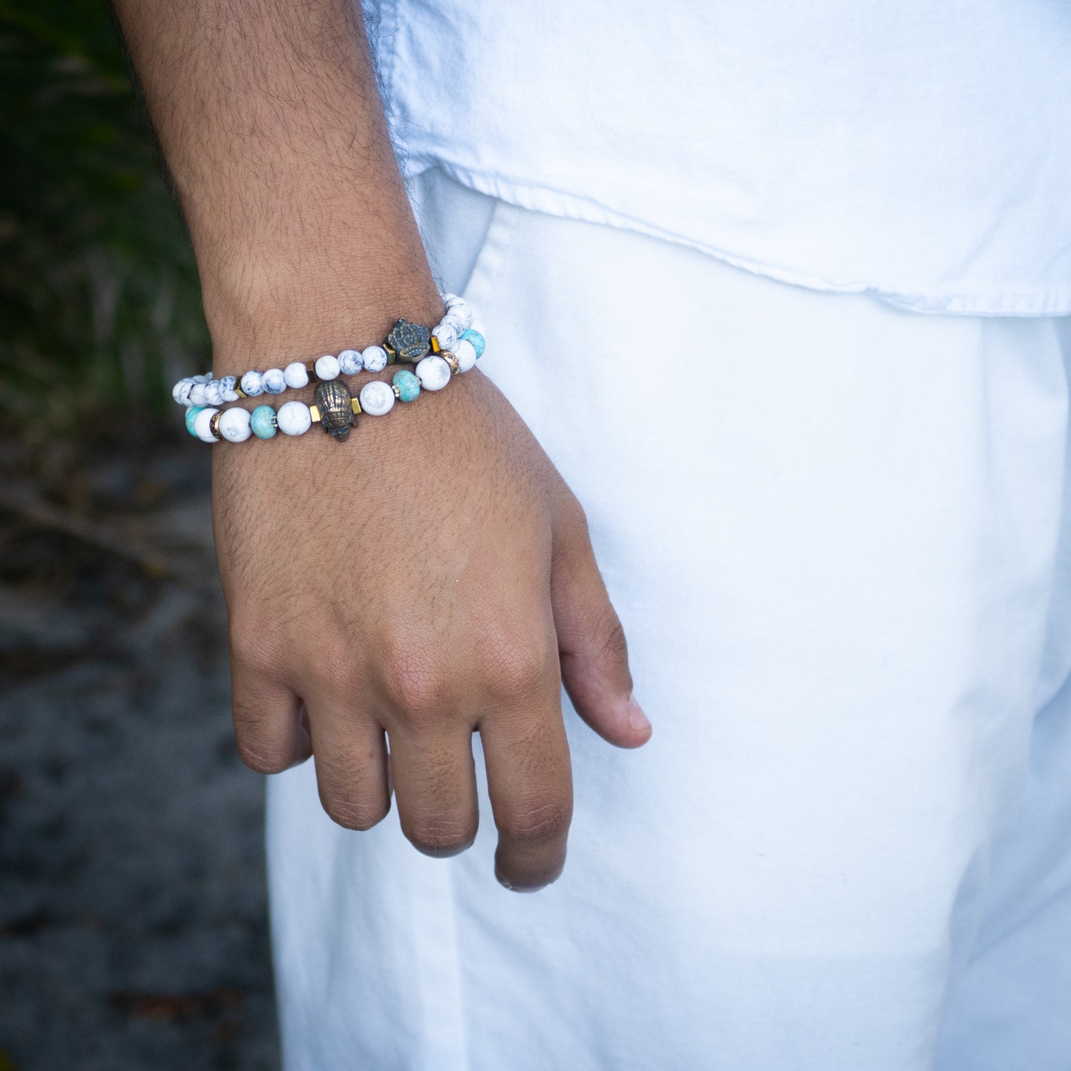 Handmade bracelet featuring calming white howlite stones and regal bronze crown charm.