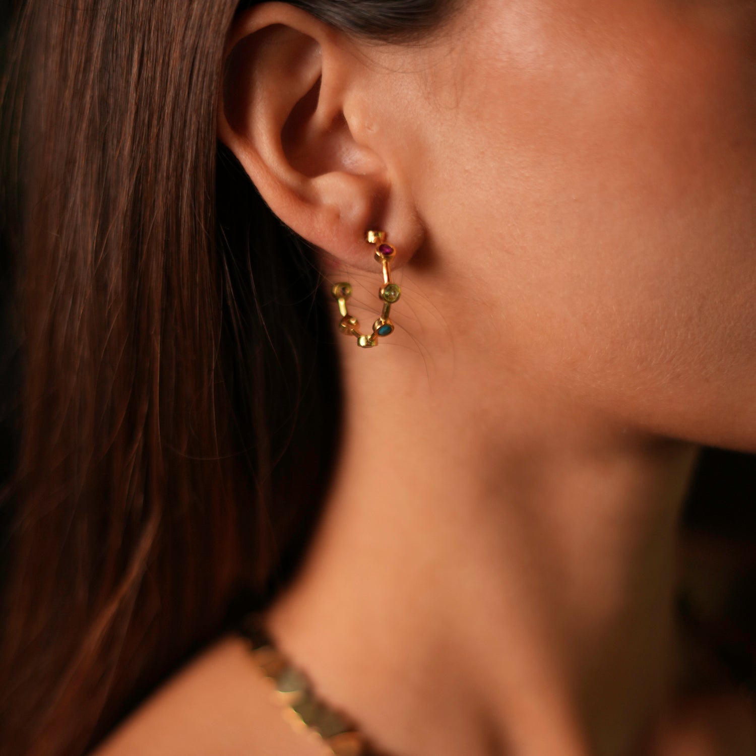 Colorful gold hoop earrings featuring round turquoise, ruby, emerald, and quartz gemstones, designed to bring joy and elegance.