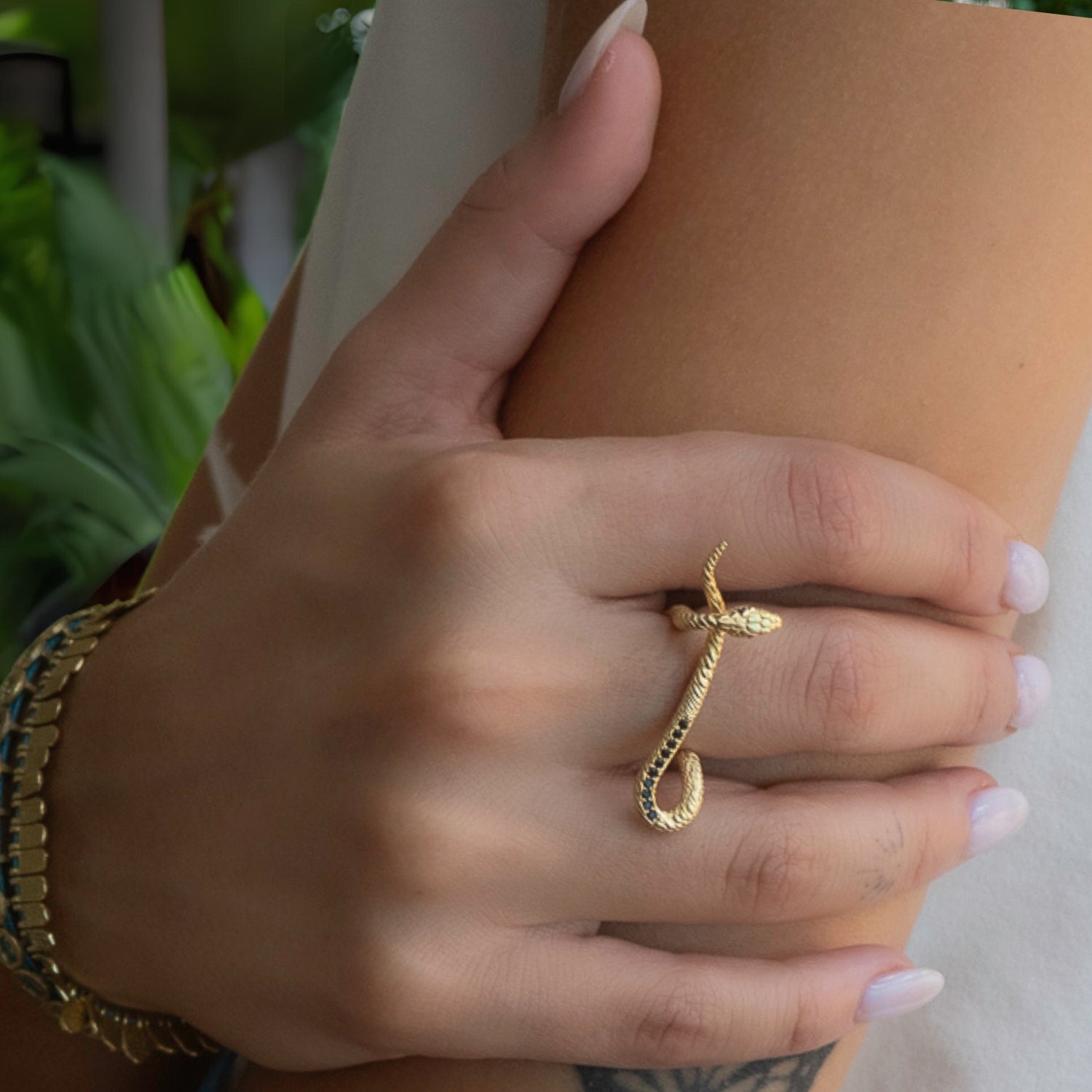 Elegant snake ring crafted from 18K gold-plated sterling silver with sparkling black Cz diamonds.