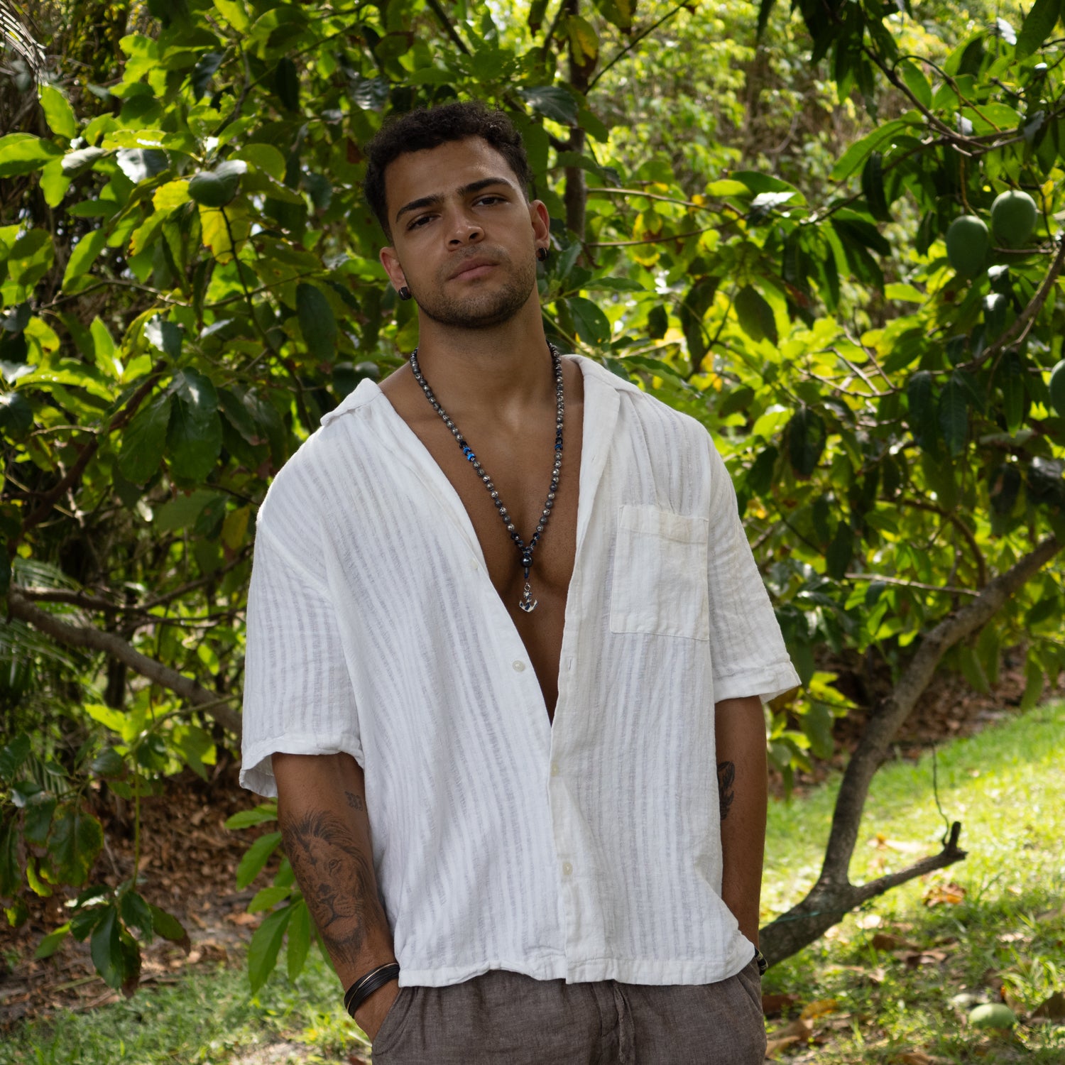 Nautical necklace for men with grounding lava beads, balance-enhancing hematite, and anchor pendant.