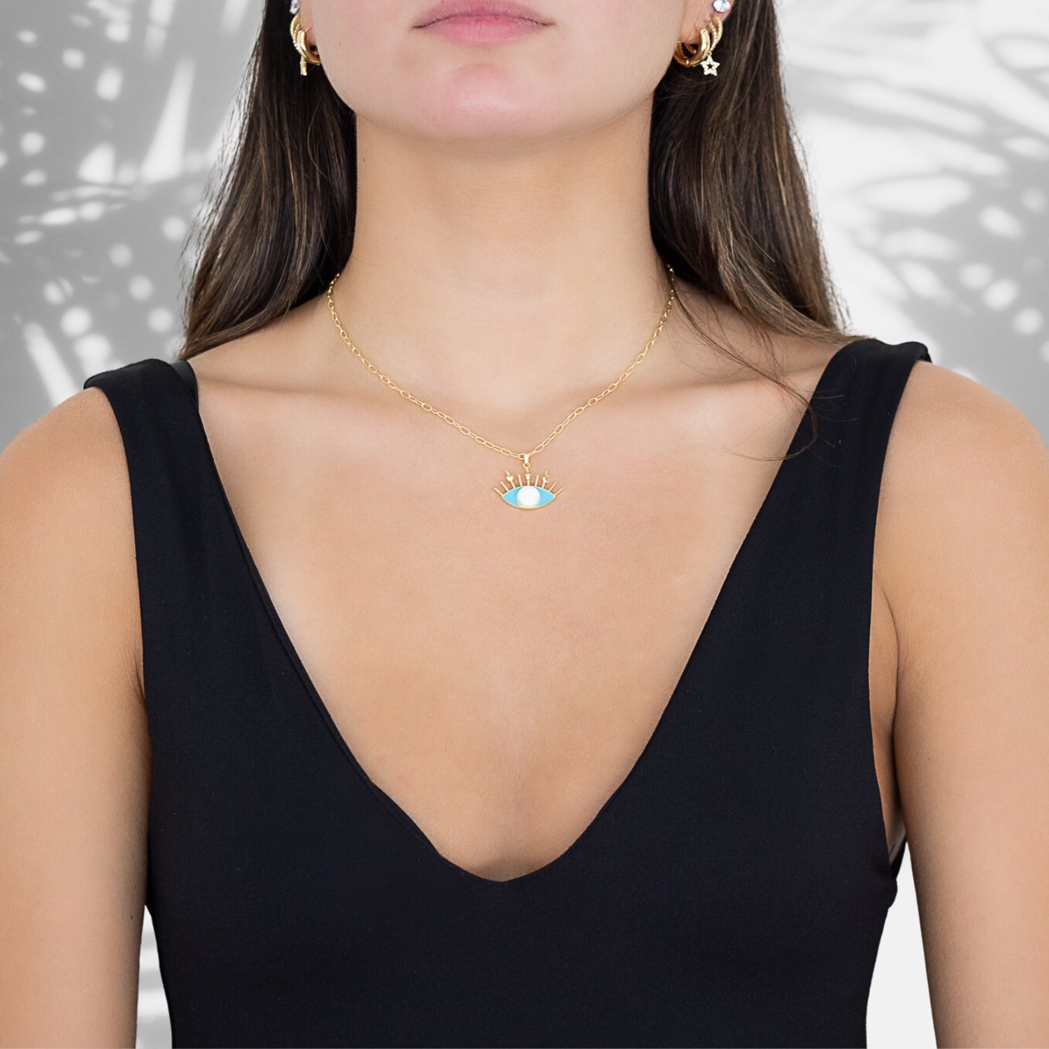 A model wearing the Opal Turquoise Evil Eye Necklace, exuding style and spiritual energy.