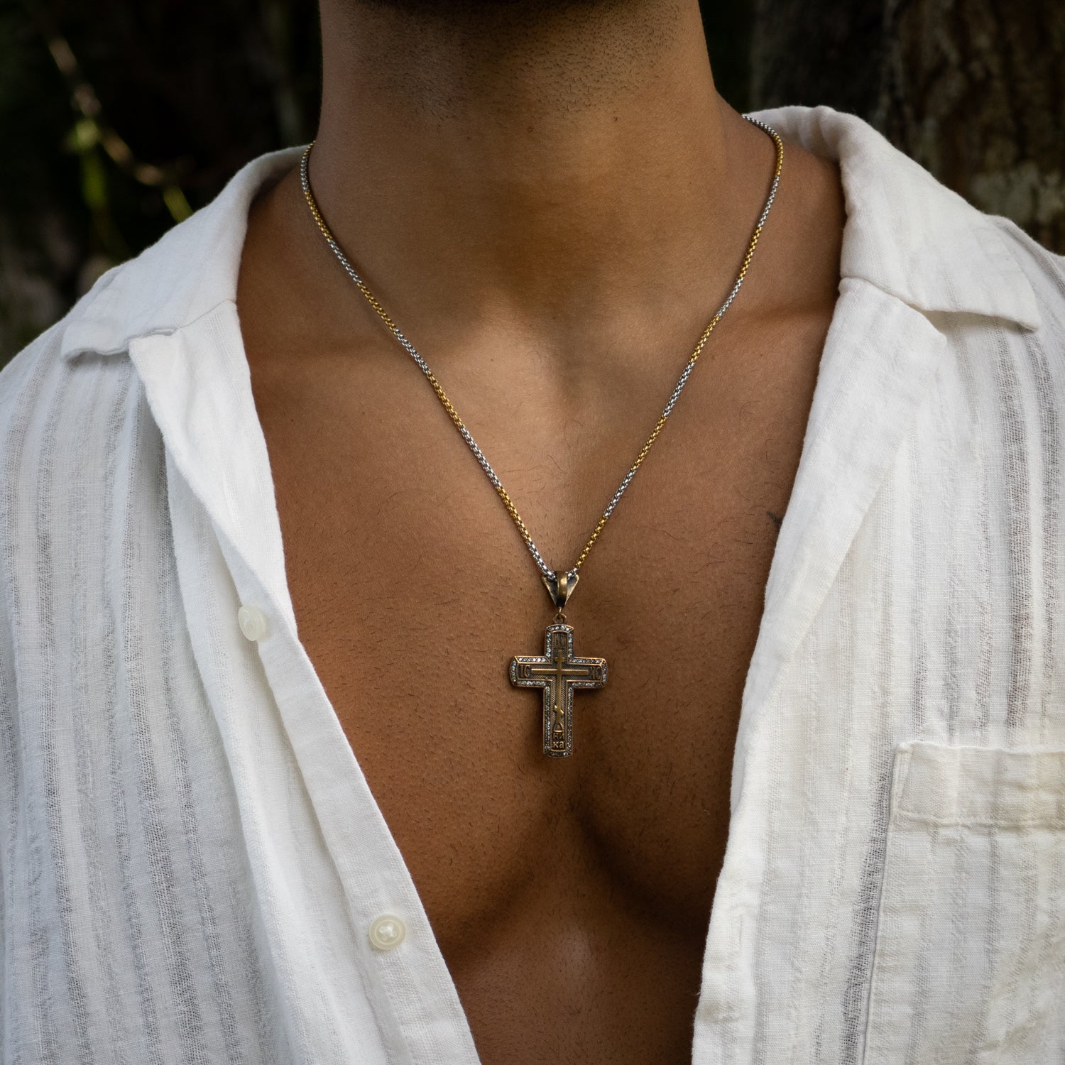 Elegant sterling silver necklace featuring an 18k gold-plated cross with sparkling pave diamonds.