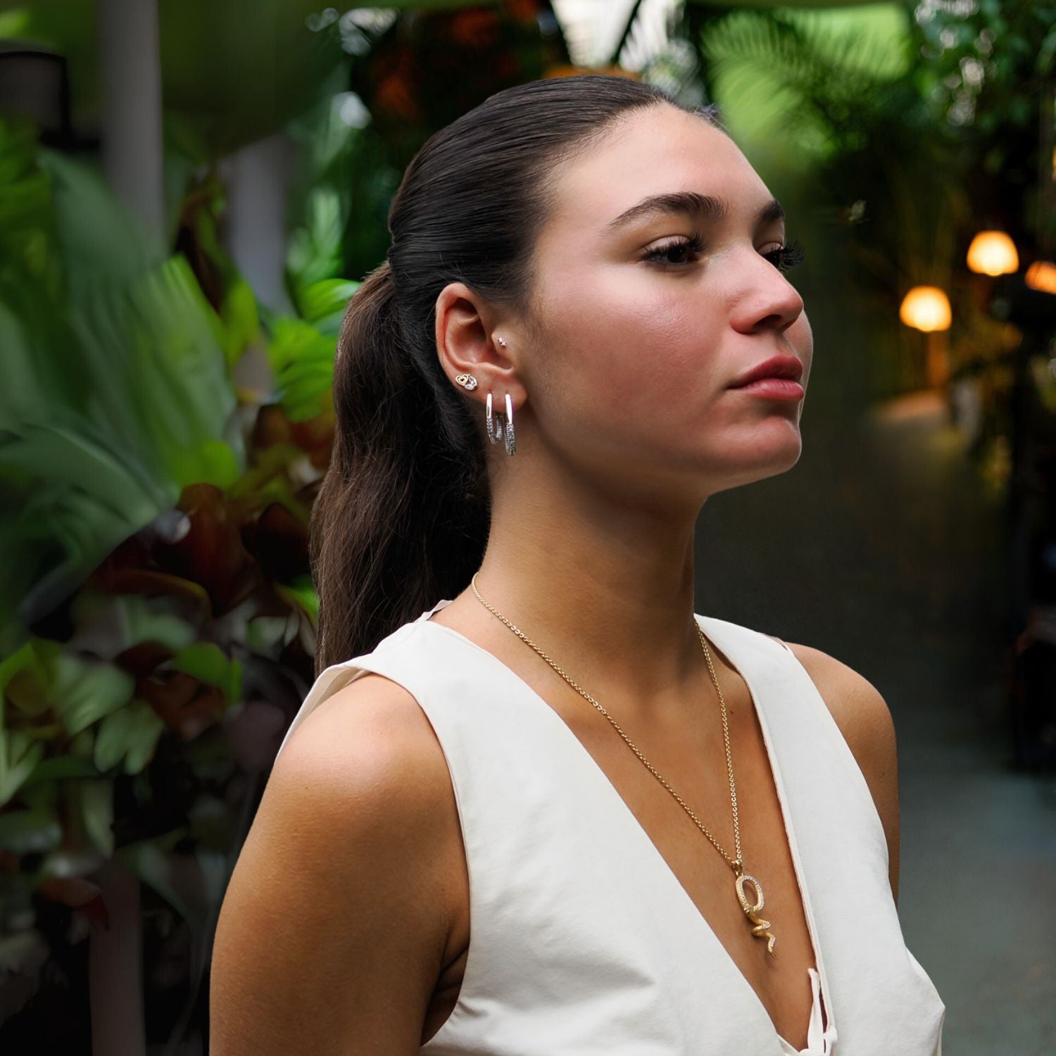 Luxurious gold hoop earrings featuring pave CZ diamonds and a polished mid-size silhouette.