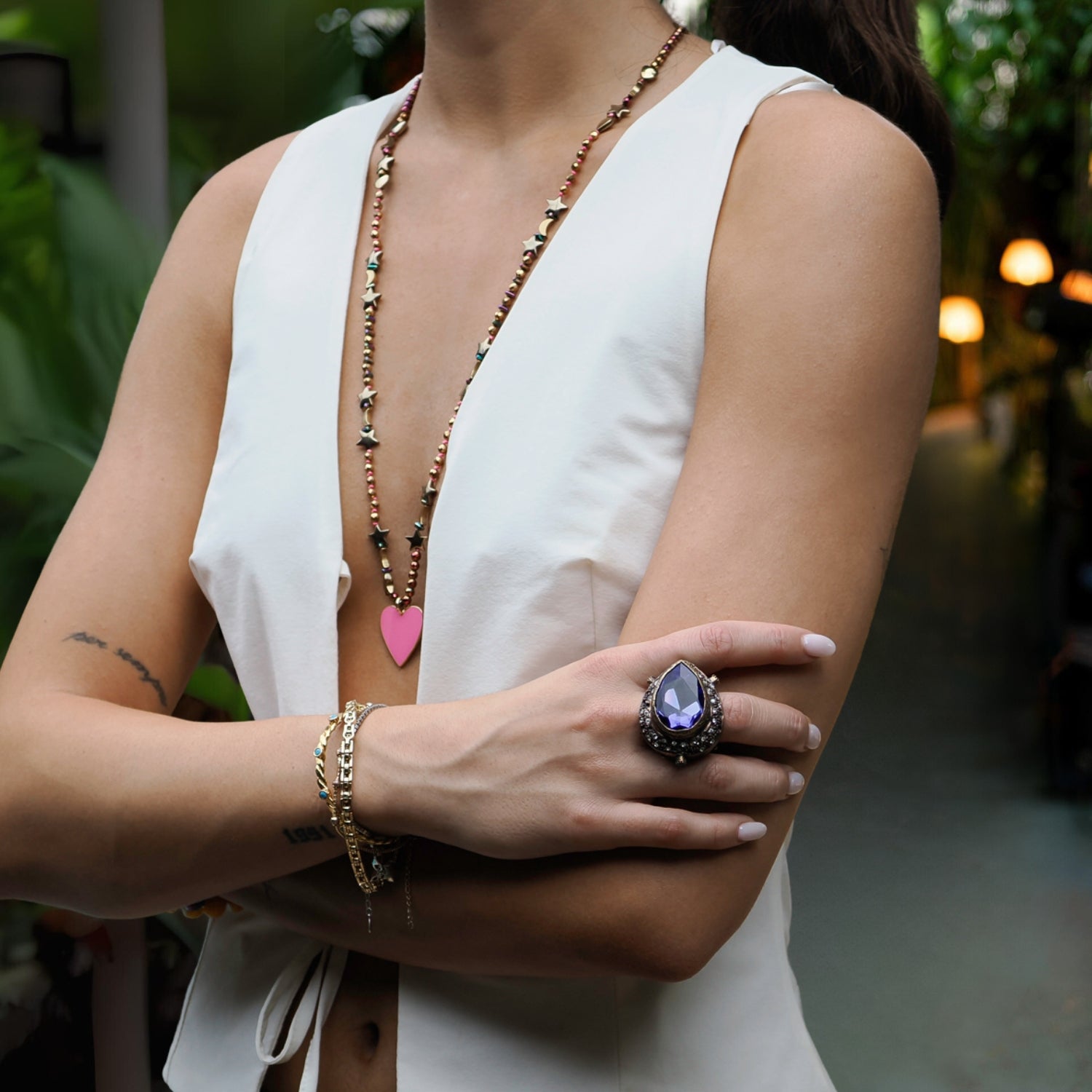 30-inch handmade necklace with multicolor hematite beads, a pink enamel heart pendant, and celestial accents.