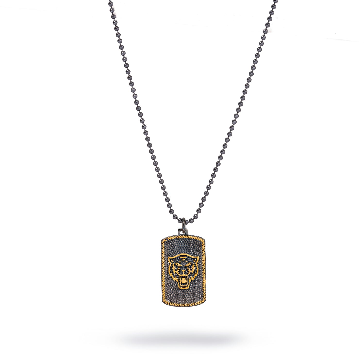 Close-up of bold lion pendant necklace with silver chain and gold detailing.