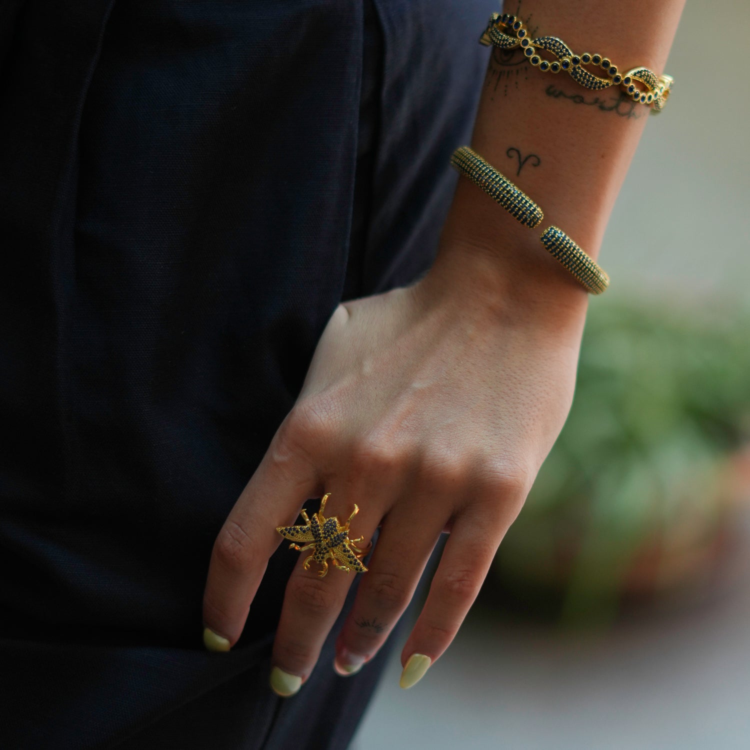 Gold Chunky Ring with Sapphire Accents and Queen Bee Motif for a Powerful, Elegant Look