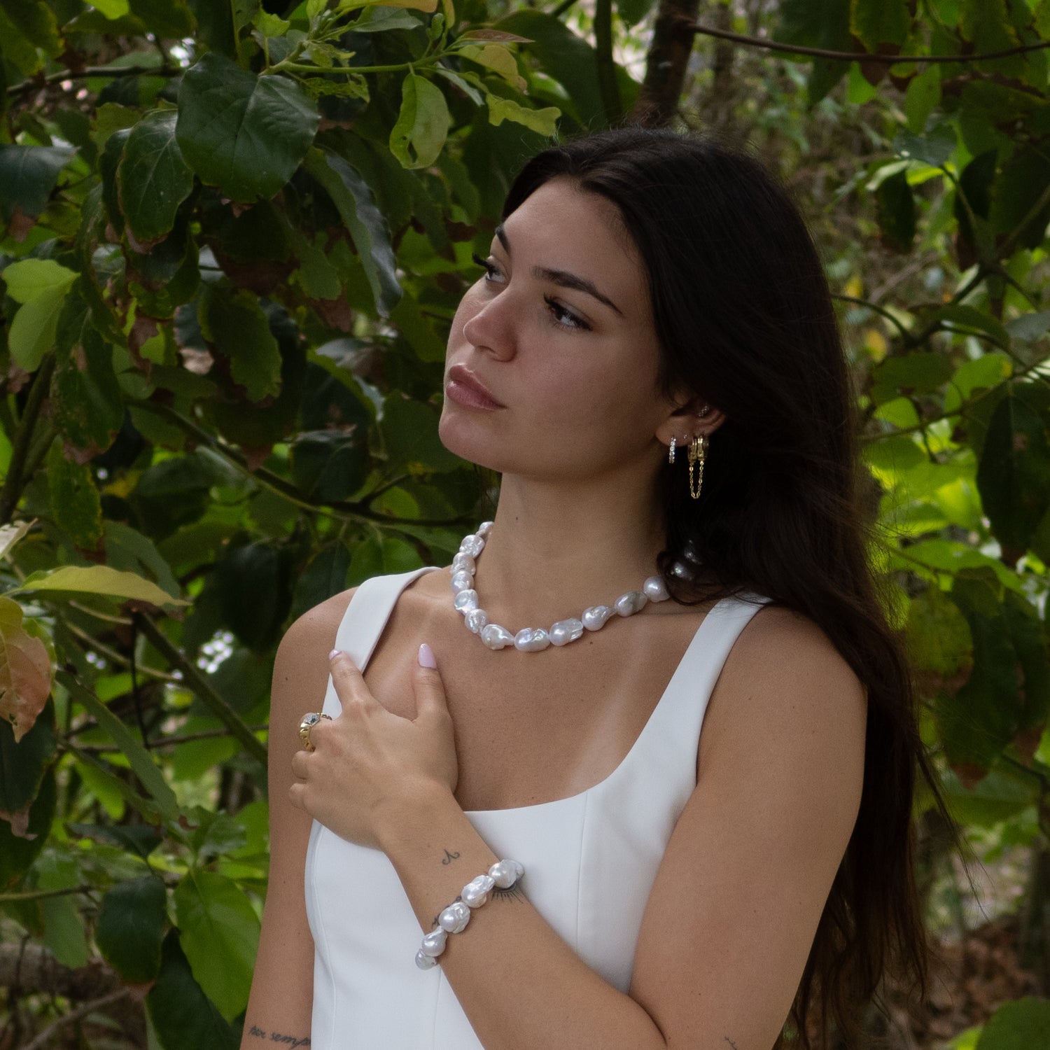 Handmade bracelet featuring irregular baroque pearls and gold-toned closure