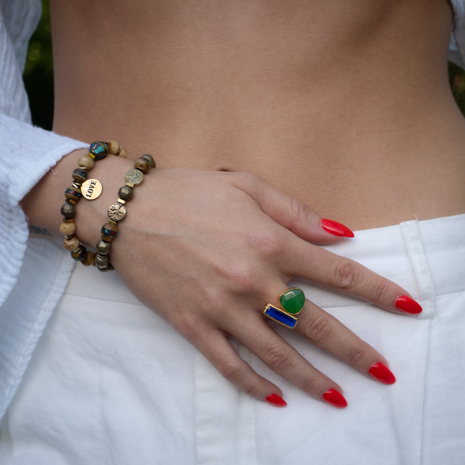 Gold-plated statement ring with healing emerald and wisdom-filled sapphire accents