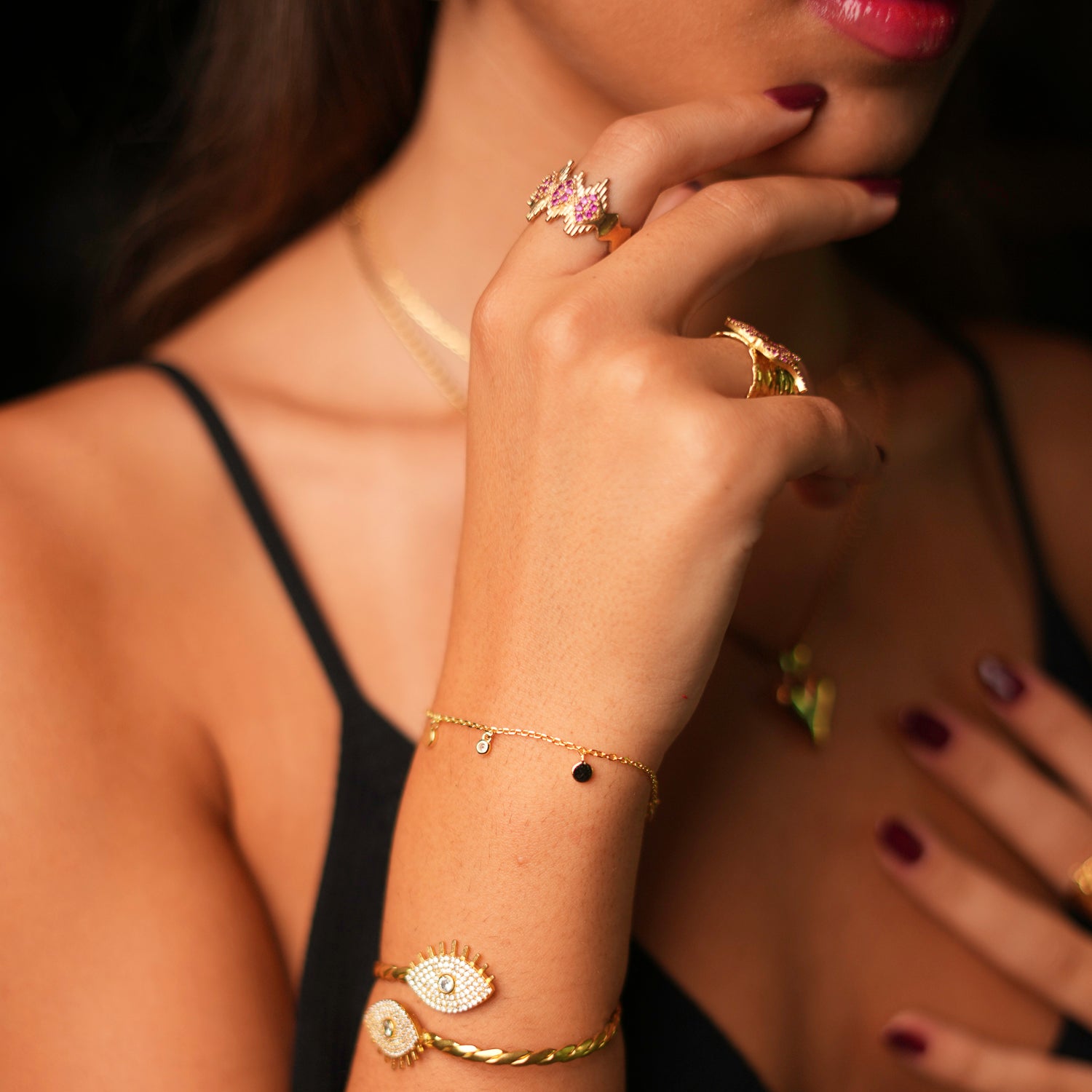 Elegant 24k gold-plated ring with ruby stones and a geometric crown design, offering an adjustable fit for a stylish and bold look.