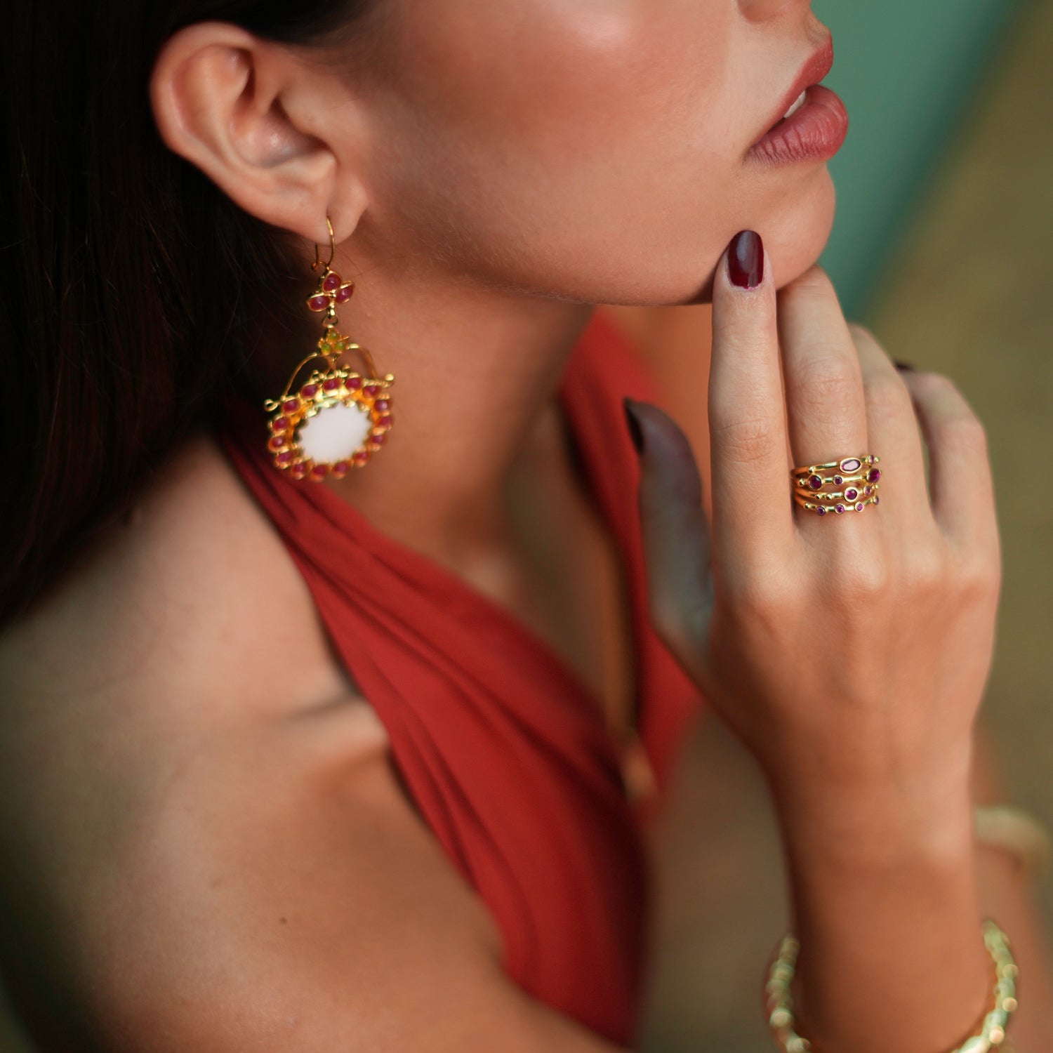 Stunning adjustable statement ring with varying sizes of ruby stones against a 24k gold-plated backdrop, offering a radiant and timeless elegance.