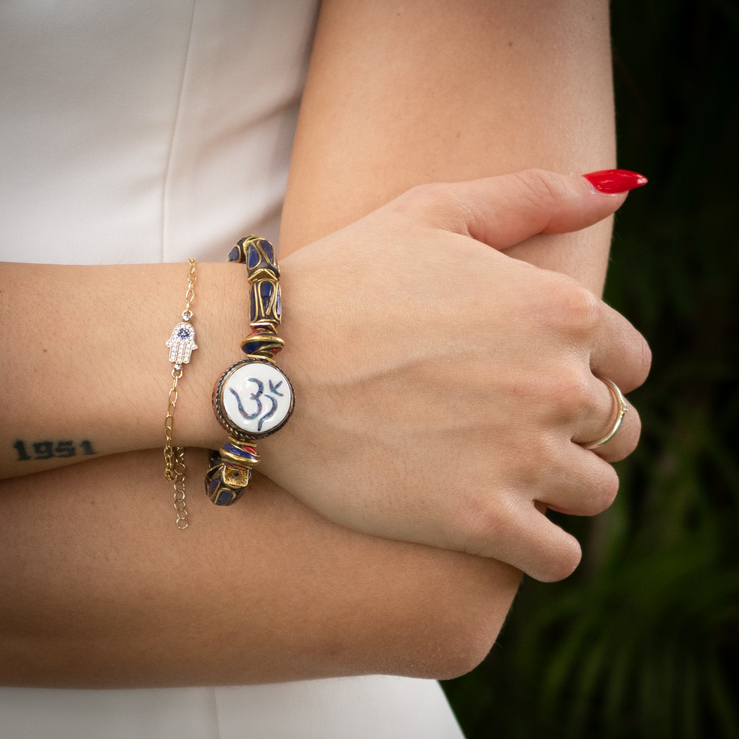 Handmade spiritual bracelet featuring coral inlay OM symbol bead from Nepal