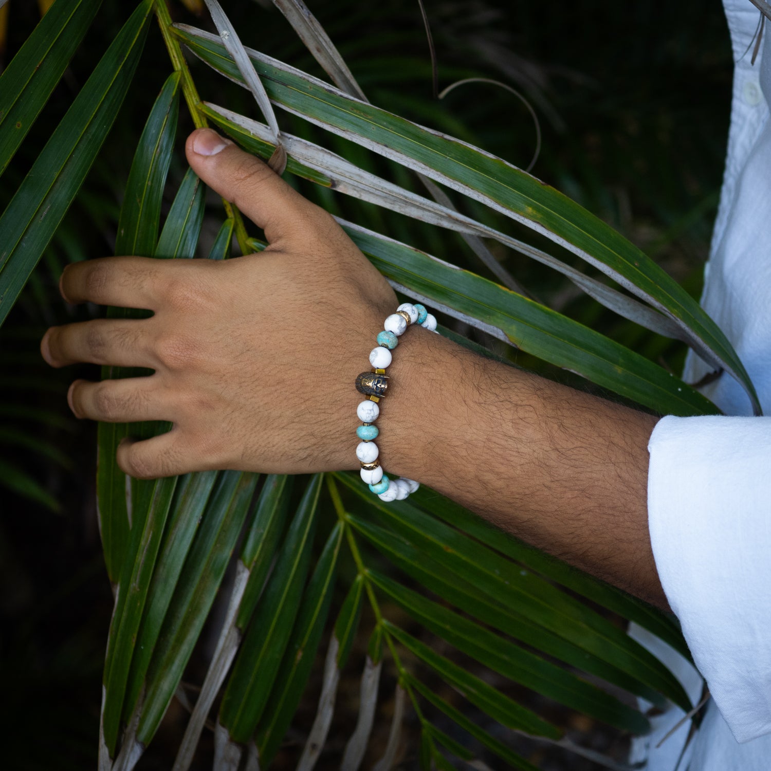 Artisan bracelet combining turquoise, white howlite, and bronze Indian bead for cultural style.