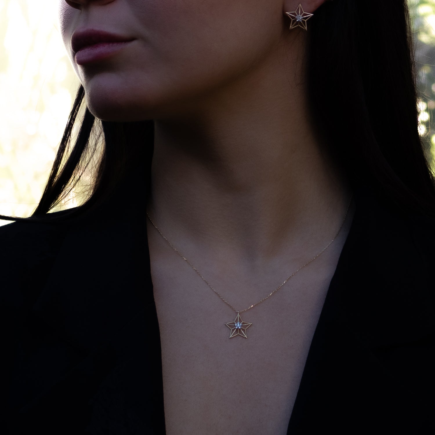 Spiritual gold necklace with a floral diamond guiding star pendant on adjustable chain