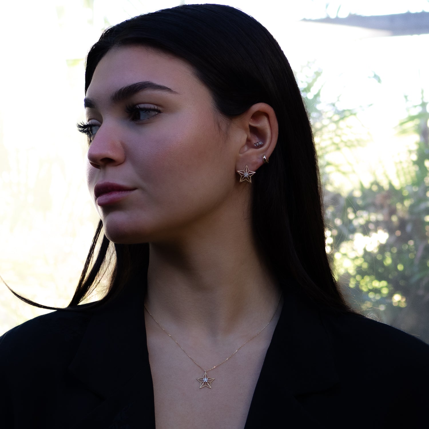 Star-shaped gold earrings with central floral diamond motif for elegance and spiritual symbolism