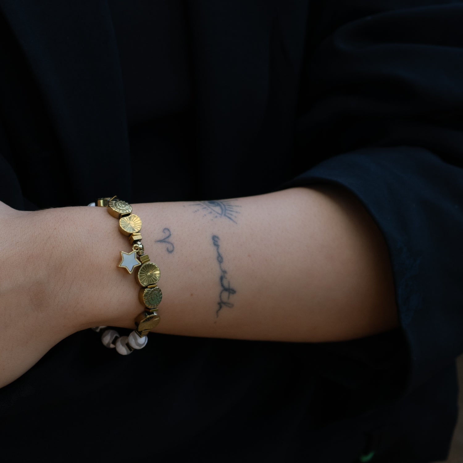 Handmade bracelet featuring Tibetan agate stones, large jade bead, and gold hematite spiral