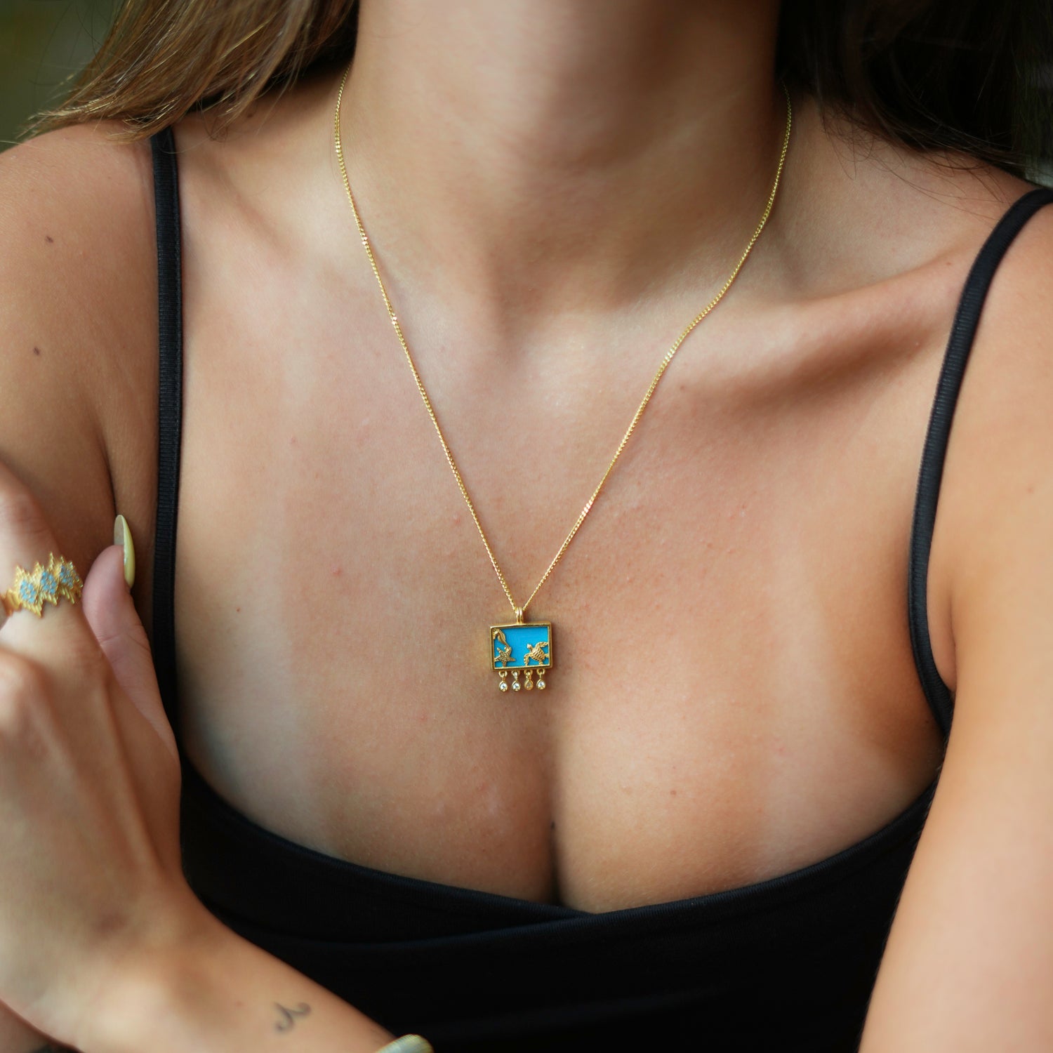 Handmade Gold Necklace with Turquoise Background and Starfish, Seahorse, and Turtle Motifs for Spiritual Energy