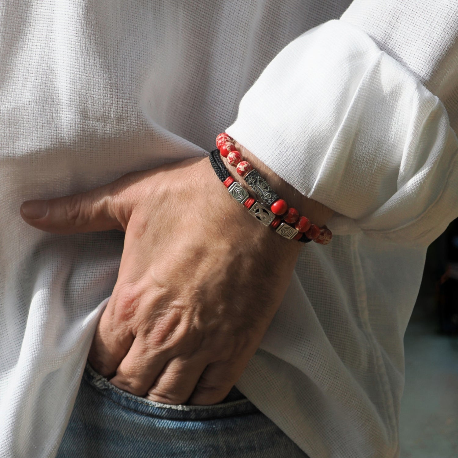 Handcrafted bracelet with 8mm red jasper beads and a sterling silver Evil Eye bead for positive energy.