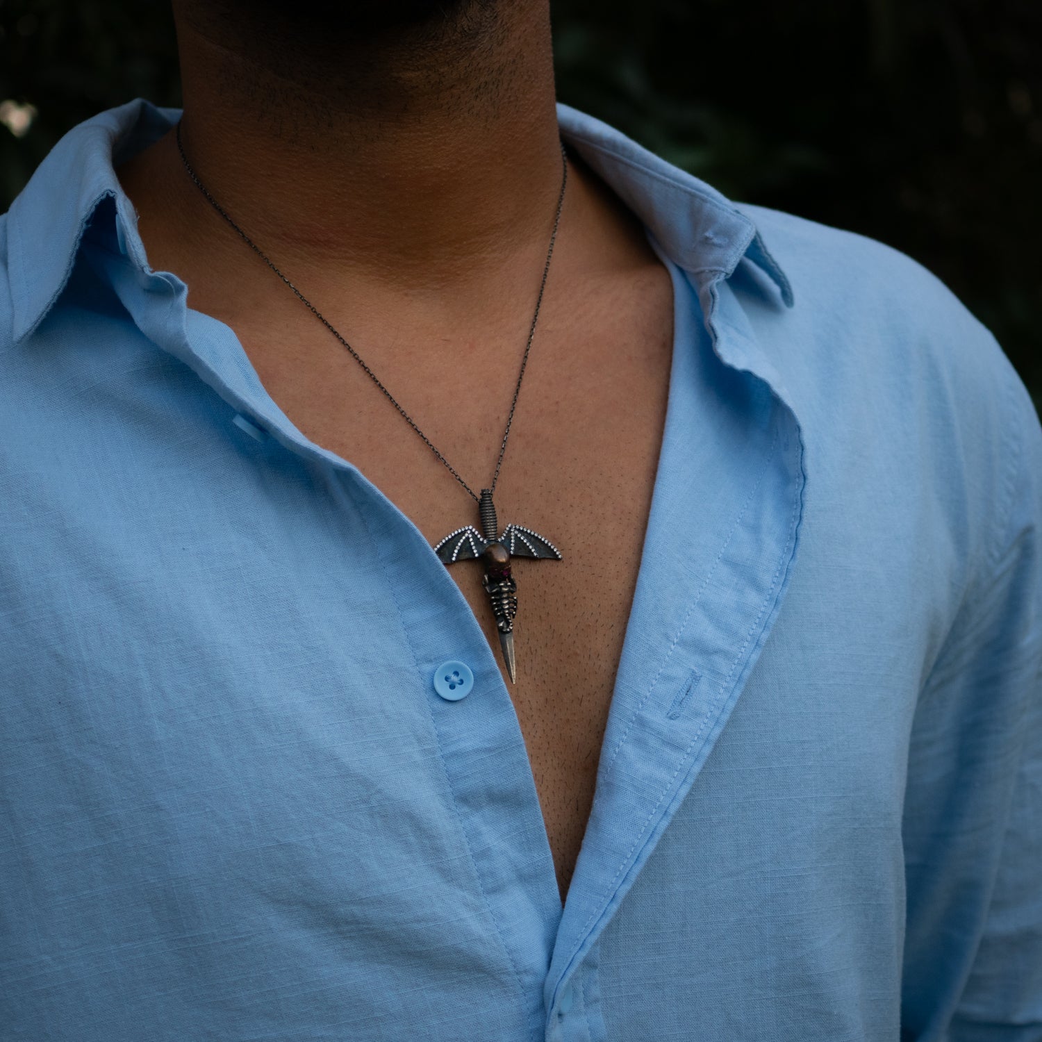 Skull sword pendant necklace in sterling silver with ruby and zircon stones for bold style.