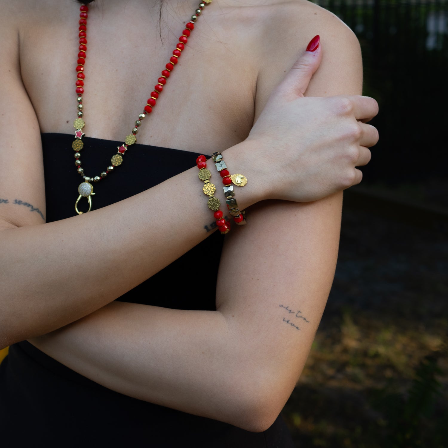 Handmade bracelet duo featuring gold-plated elephant charm and red crystal beads