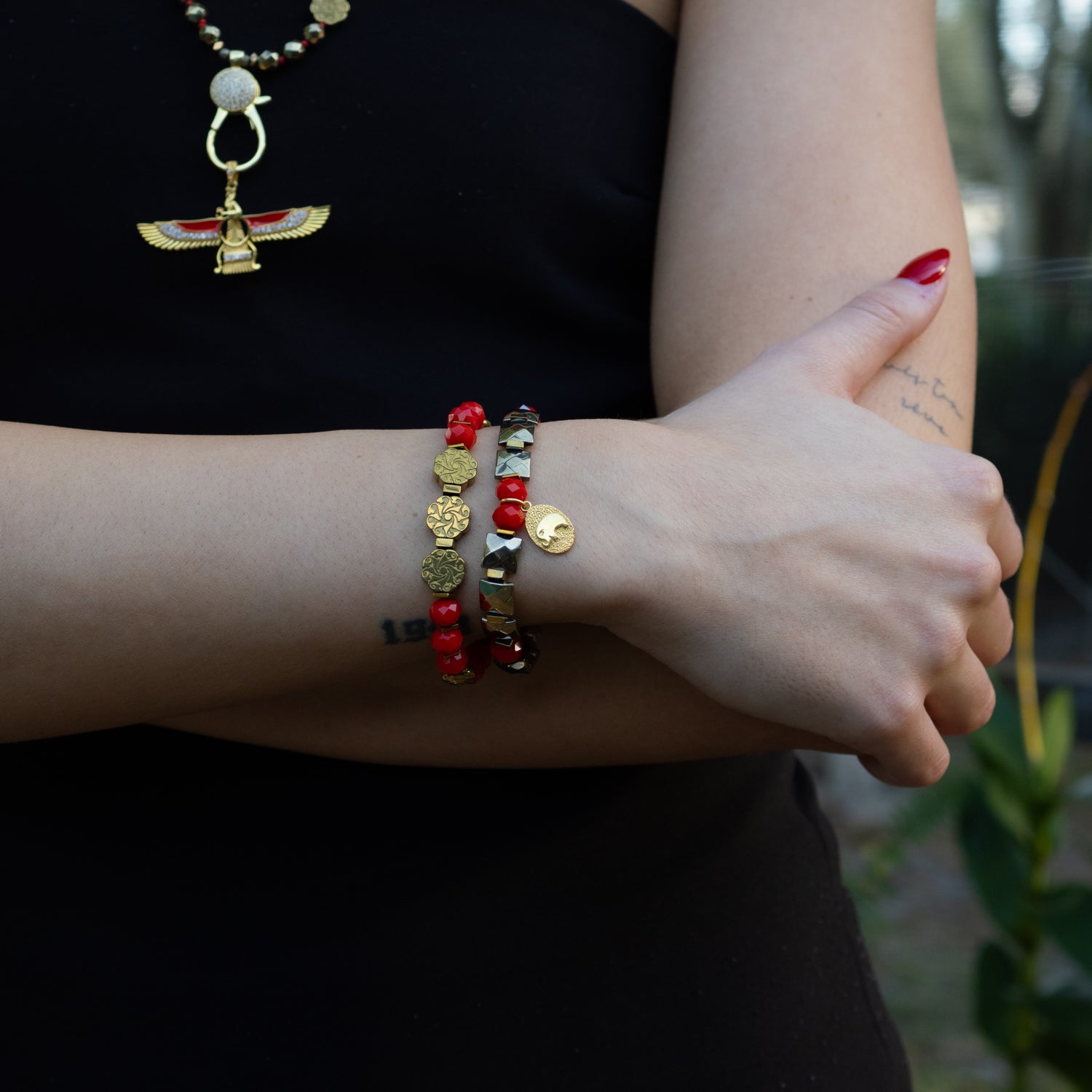 Spiritual bracelet set with red energy crystals, gold hematite, and symbolic charms