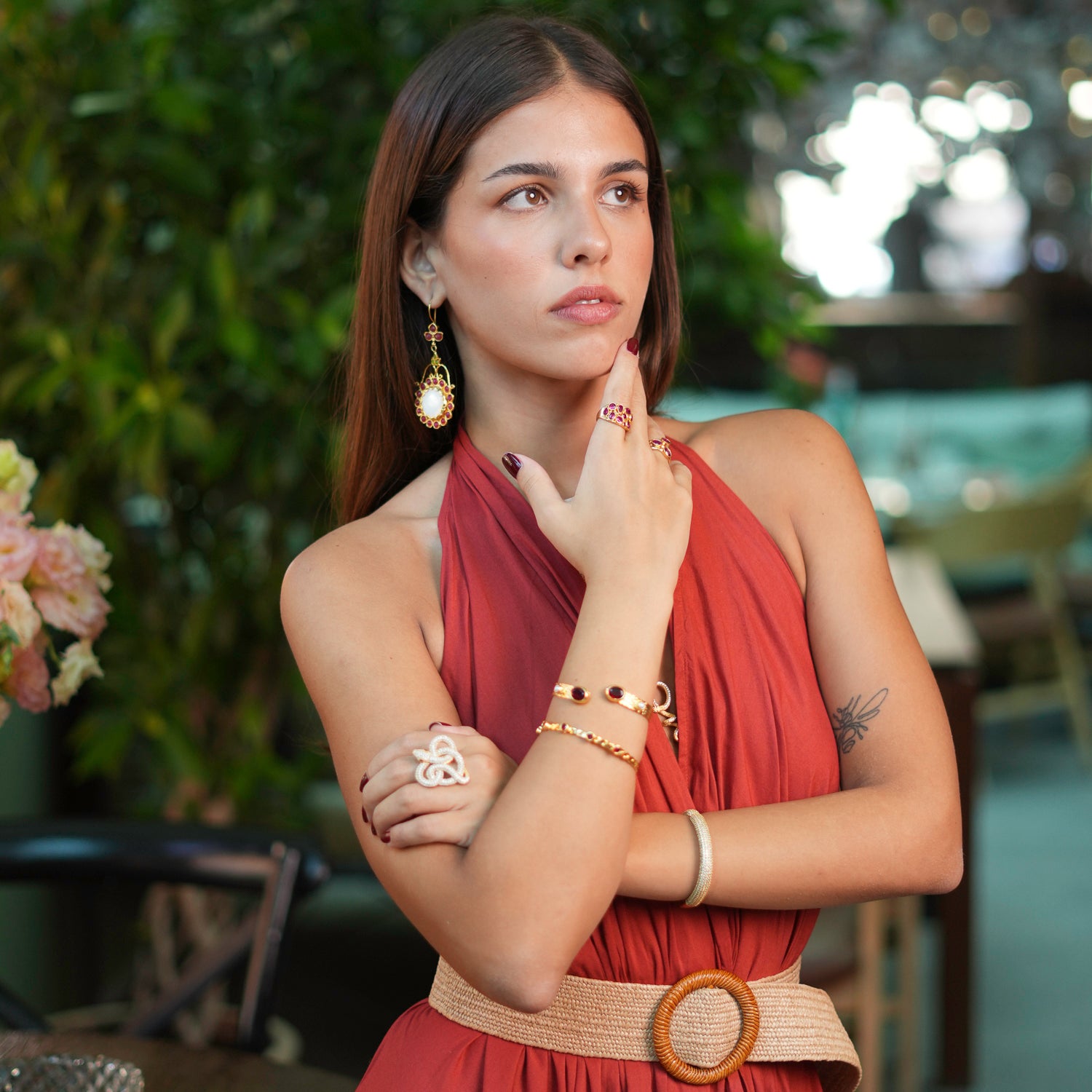 Glamorous 24k gold-plated ring with teardrop-shaped rubies, adjustable for a comfortable fit and eye-catching appeal.