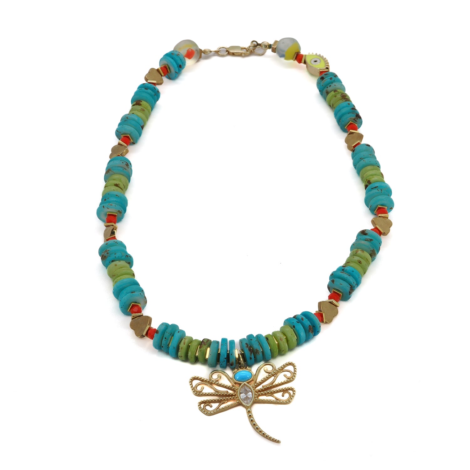 Close-up of a vibrant necklace with a turquoise-adorned dragonfly pendant, gold hematite beads, and a yellow Evil Eye charm.